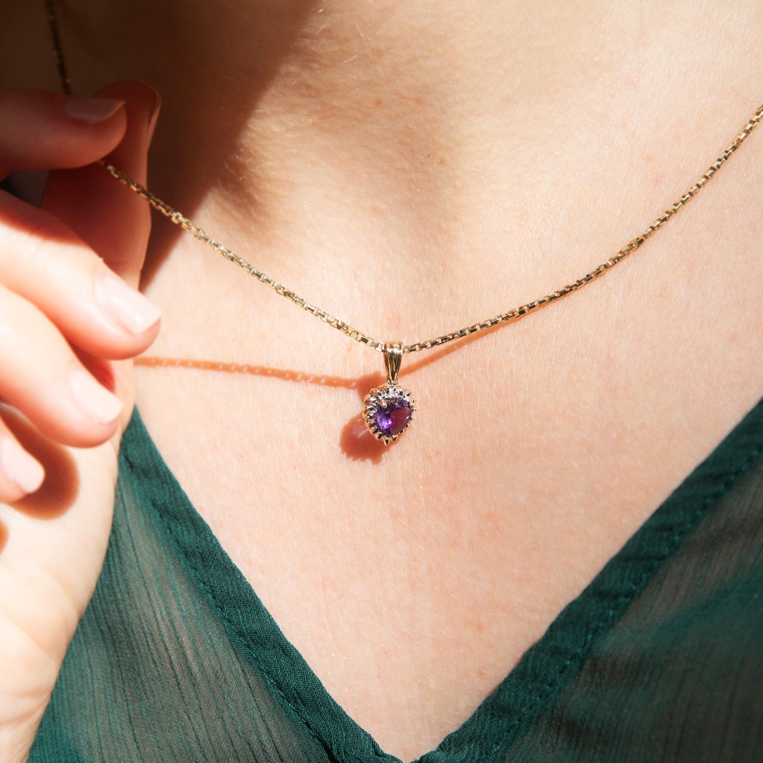 Crafted in 14 carat gold, this charming vintage pendant, circa 1990s, features a darling heart-shaped amethyst in a claw setting articulating from an elegant bail threaded with a fine belcher chain. Her name is The Elise Pendant & Chain. She is an