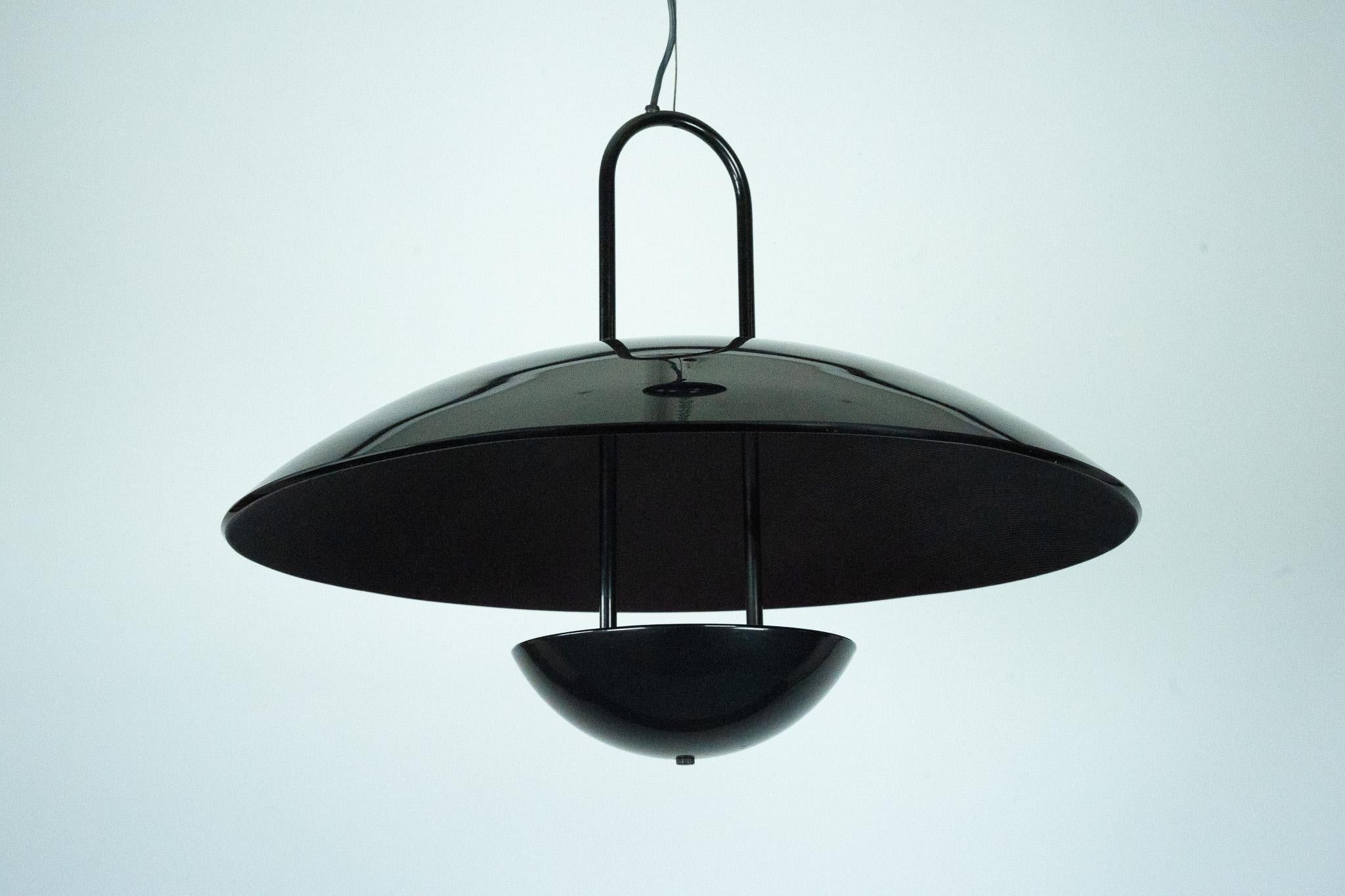 Elegant pendant lamp from the 1990s featuring a distinctive modernist design. The lamp showcases a glossy black finish and a sculptural double-dome structure — a large glass shade paired with a smaller lower bowl that houses the bulb. The upper