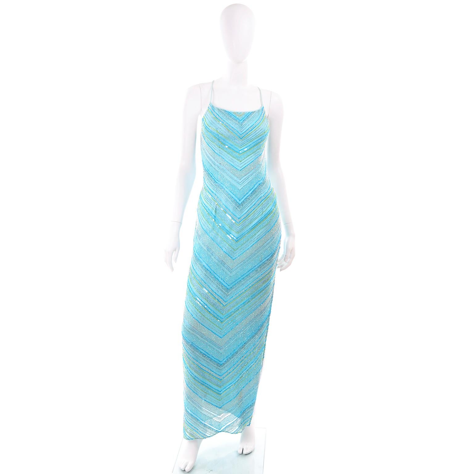 This is a stunning vintage 1990's beaded gown with thin criss cross straps over a scooped, open back. There are a variety of shades of blue beads that form a chevron pattern. Unfortunately, the label has been removed but it is such a beautiful