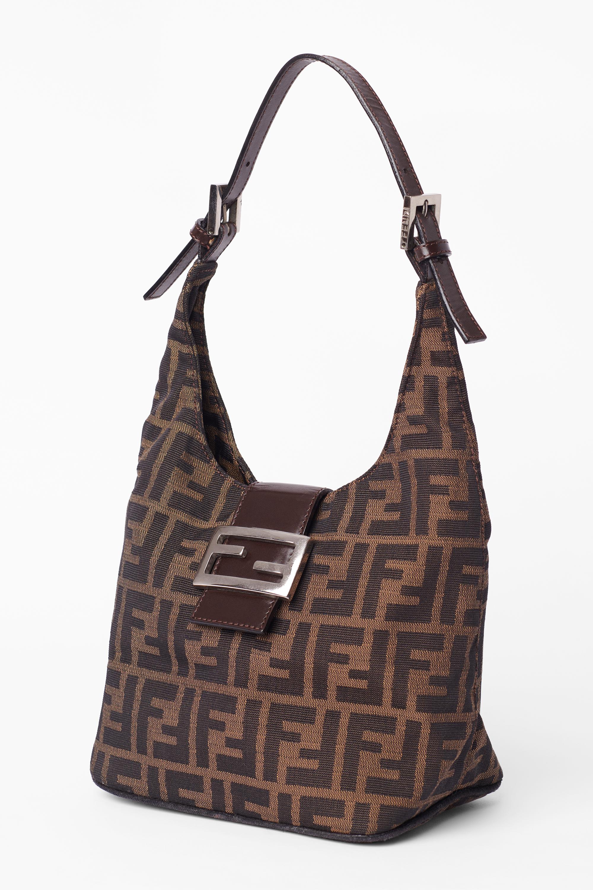 Vintage Fendi 1990’s croissant bag. Features brown zucca monogram print allover, back interior zip pocket, iconic Fend silver hardware, leather strap with adjustable length and Fendi hardware buckles. 

Brand: Fendi
Color: Brown
Colour: Brown
Year/