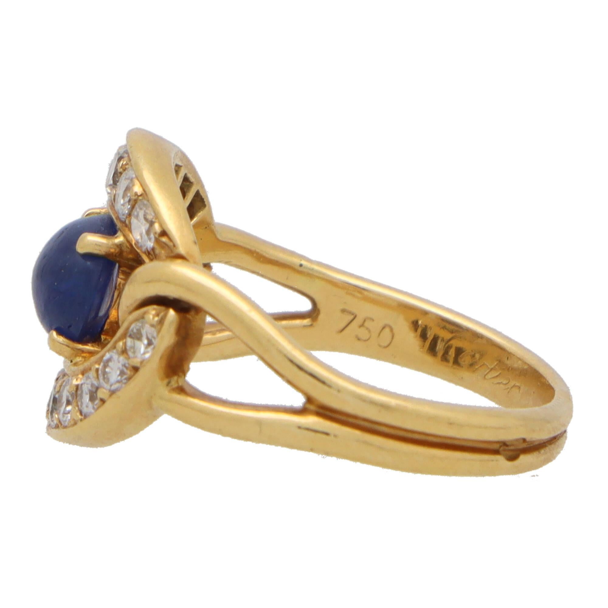  A beautiful vintage 1990's Cartier diamond and sapphire dress ring set in 18k yellow gold.

Estimated to be from the early 1990's, the ring is centrally set with a vibrant cabochon blue sapphire. The sapphire is securely four claw set to the centre