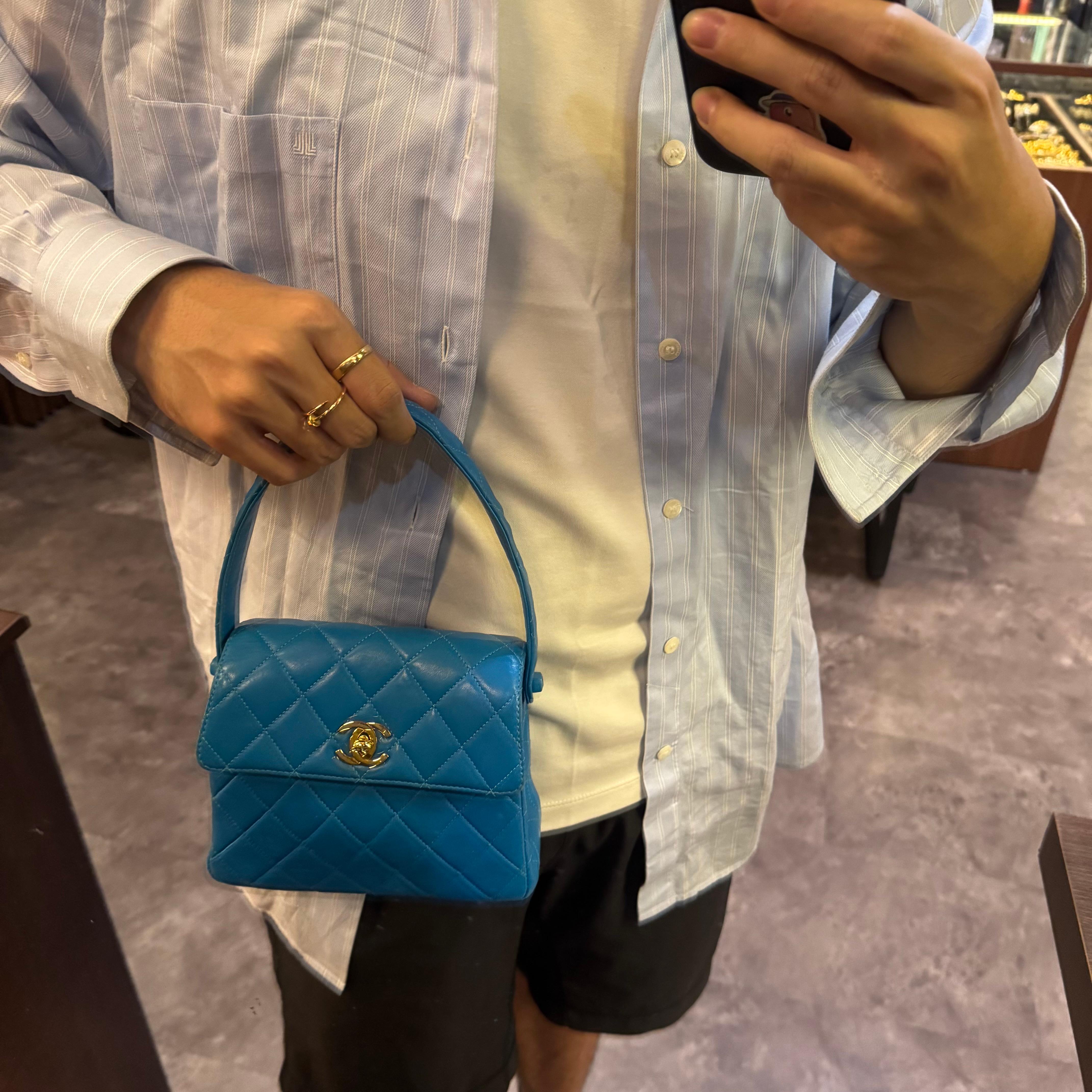 Rare vintage Chanel Turqoise lambskin top handle bag with gold hardware. Very rare color to come by. In good vintage condition. Visible scuffing and rubbing on the corners. Also rubbing on the side buttons. Series #4. Original condition. Comes with