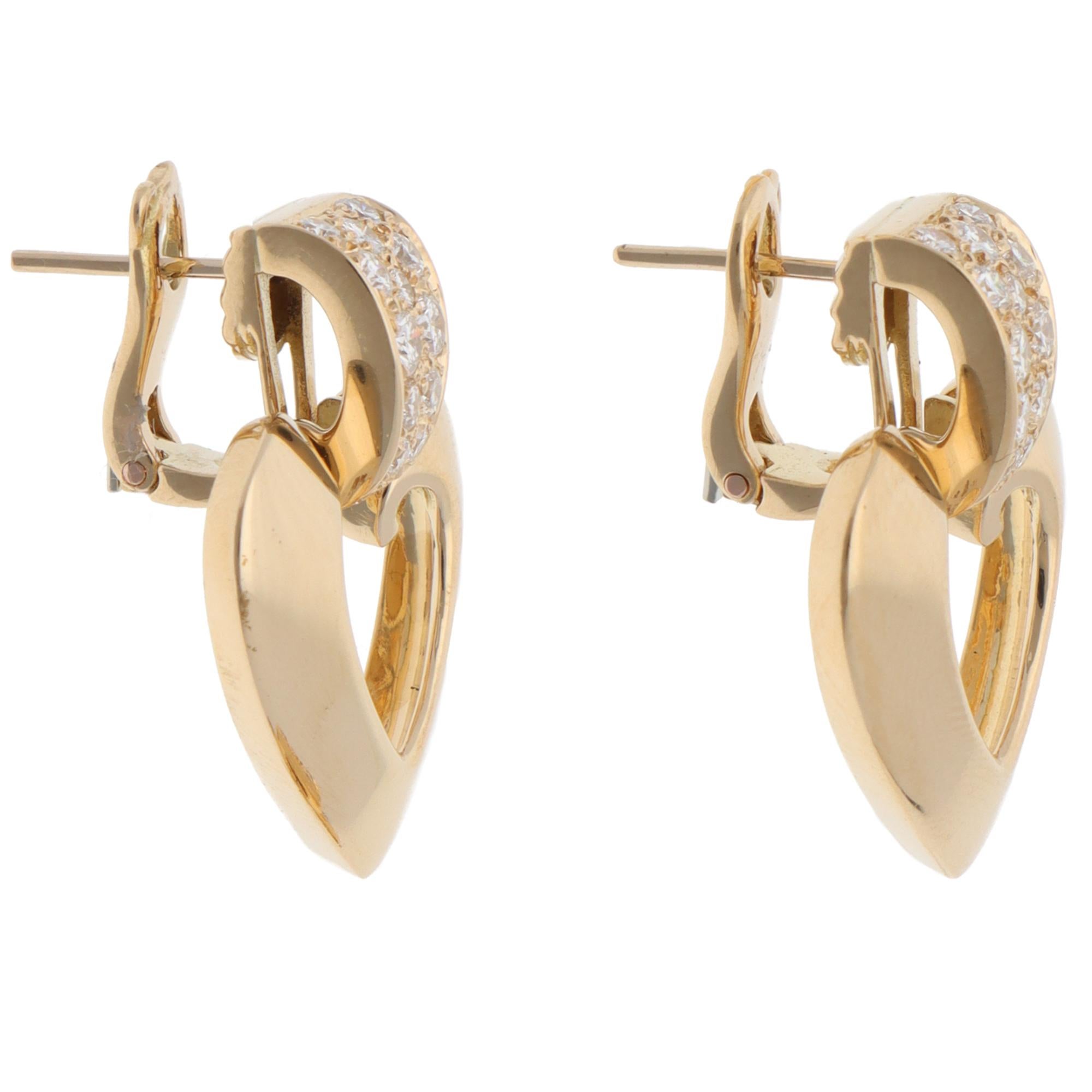 A beautiful pair of vintage Christian Dior diamond drop earrings set in 18k yellow gold, circa 1990s.

From the discontinued Dior collection, each earring is first composed of a hoop motif set with 14 round brilliant-cut diamonds. Ascending from