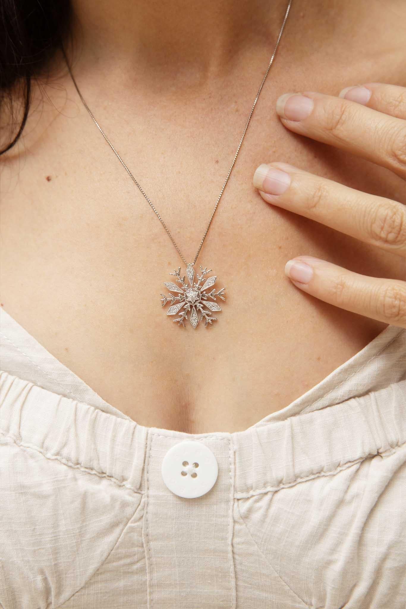 Like a fleeting winter dream, our Spencer Snowflake Pendant & Chain captures the magic of a frosty wonderland. Crafted in shimmering 18 carat white gold, this intricate snowflake pendant is adorned with dazzling diamonds that sparkle like freshly