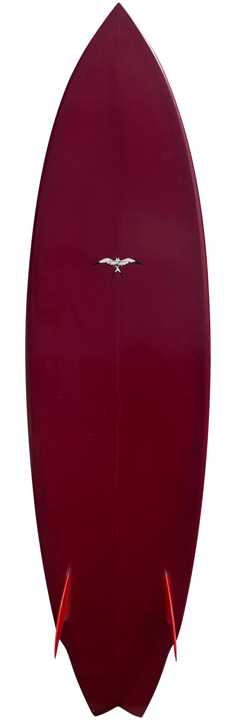 1990s Donald Takayama twin fin shortboard surfboard shaped by the late Donald Takayama (1943-2012). Features a beautiful red tint with matching red fins. Signed by the late Donald Takayama. A great example of a retro twin fin surfboard shaped by a