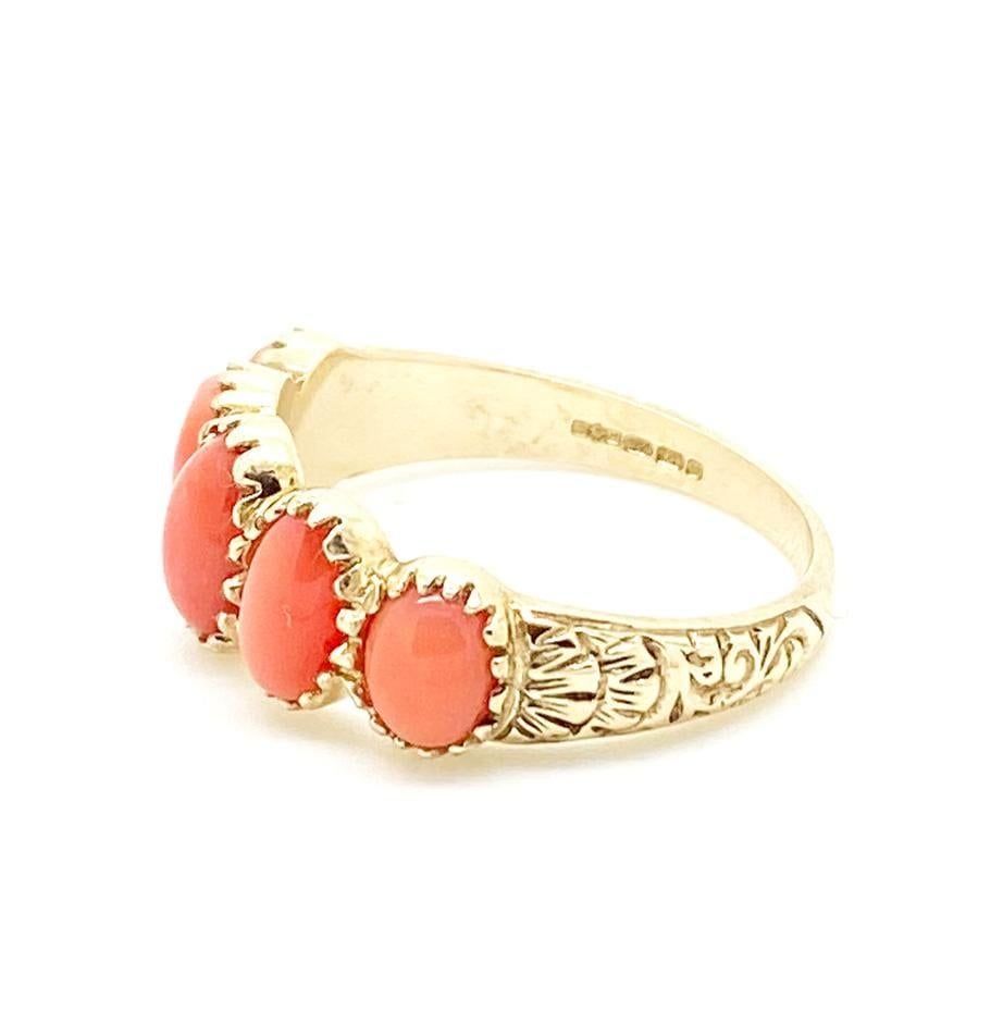 Vintage coral ring featuring five cabochon coral set with in an ornate 9ct gold setting. This beautiful ring has a number of marks indicating the piece was hallmarked in Birmingham, England set in 9ct yellow gold. 

The Victorians believed Coral