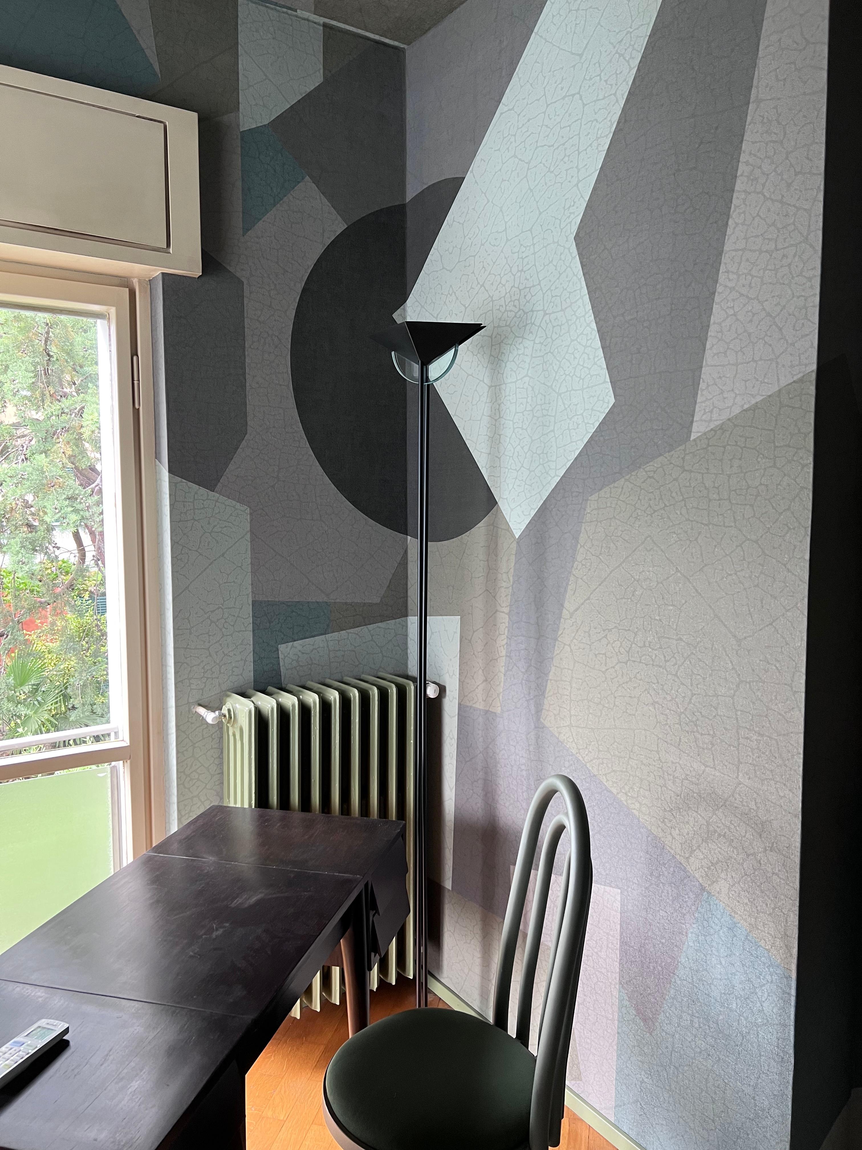 Vintage 1990s floor lamp in the style of Fontana Arte, with a metal structure painted in matte black and a rhomboidal lampshade concealing an alogen light bulb. Two decorative touches are added by a half-moon in aquamarine glass at the top, and a