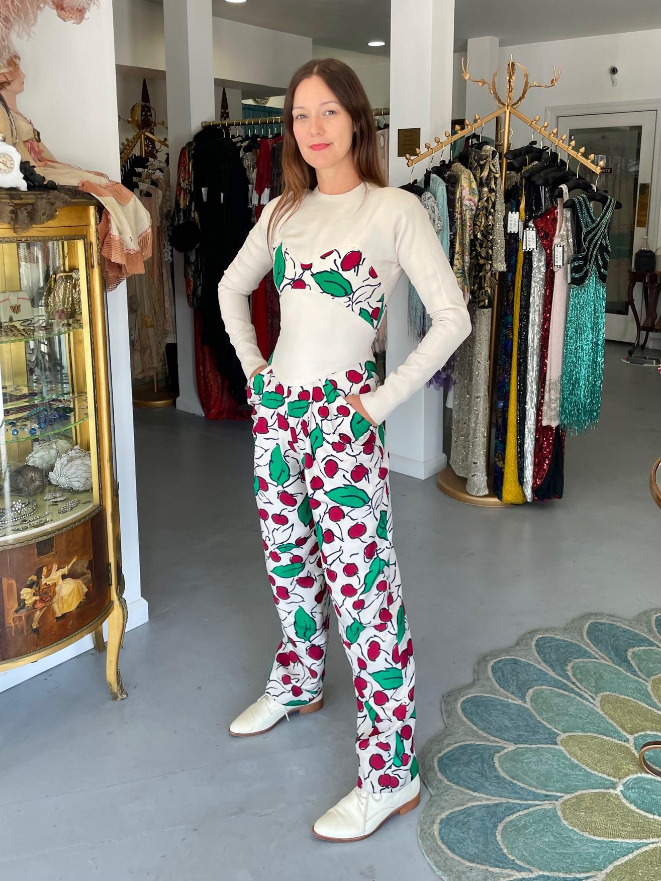 An incredibly chic and hard-to-find Geoffrey Beene cherry print silk crepe jumpsuit  dating back to the early 1990's. Geoffrey Beene's body-contoured designs were marvels of cut and proportion. There is an exhibition of his work currently running