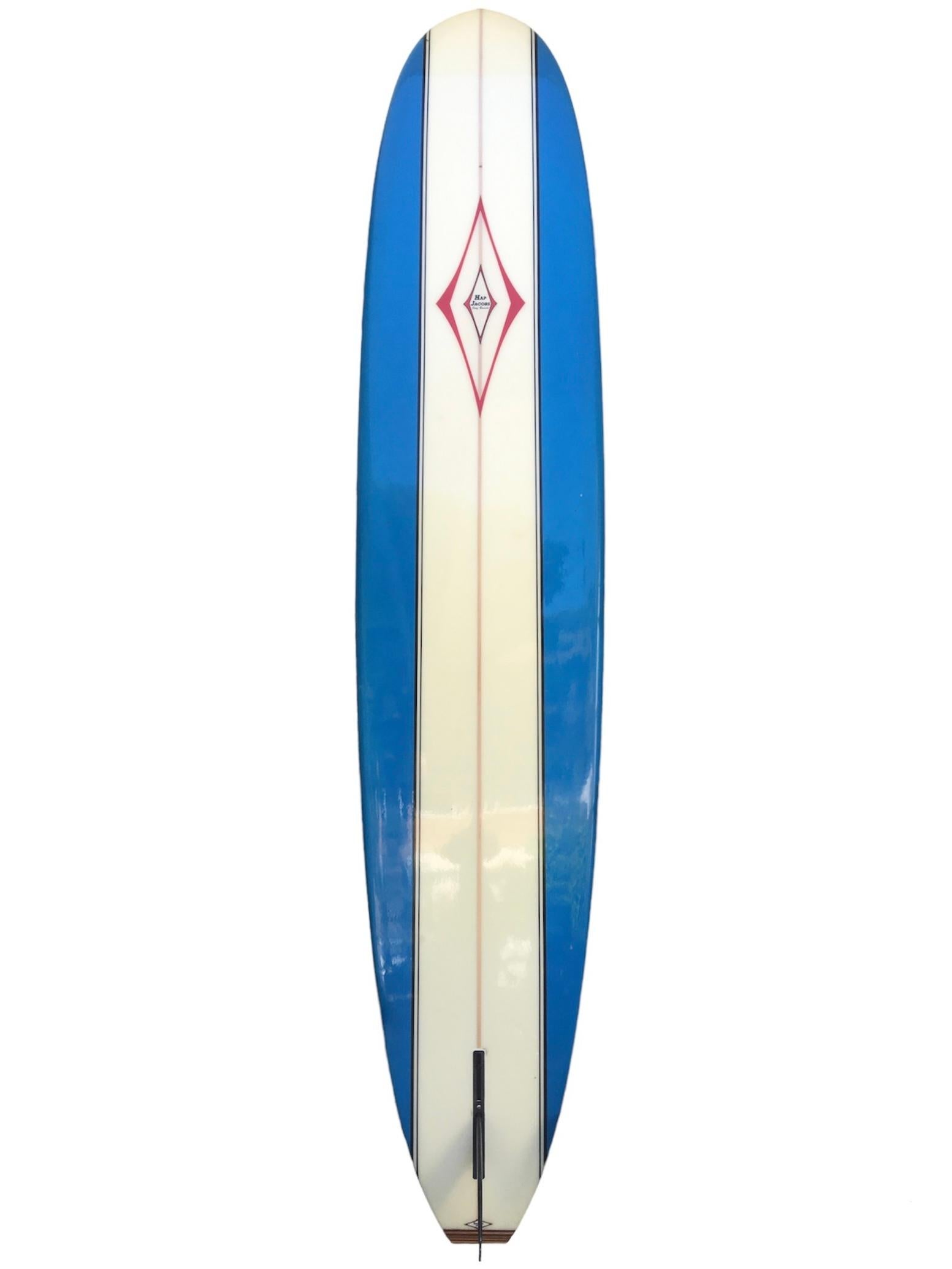 Vintage 1990s Hap Jacobs classic longboard. Hand made by the late Hap Jacobs (1930-2021). Features gorgeous blue panels with black pinstriping and beautiful wood tailblock. Hand signed by Hap Jacobs. A remarkable example of a classic longboard