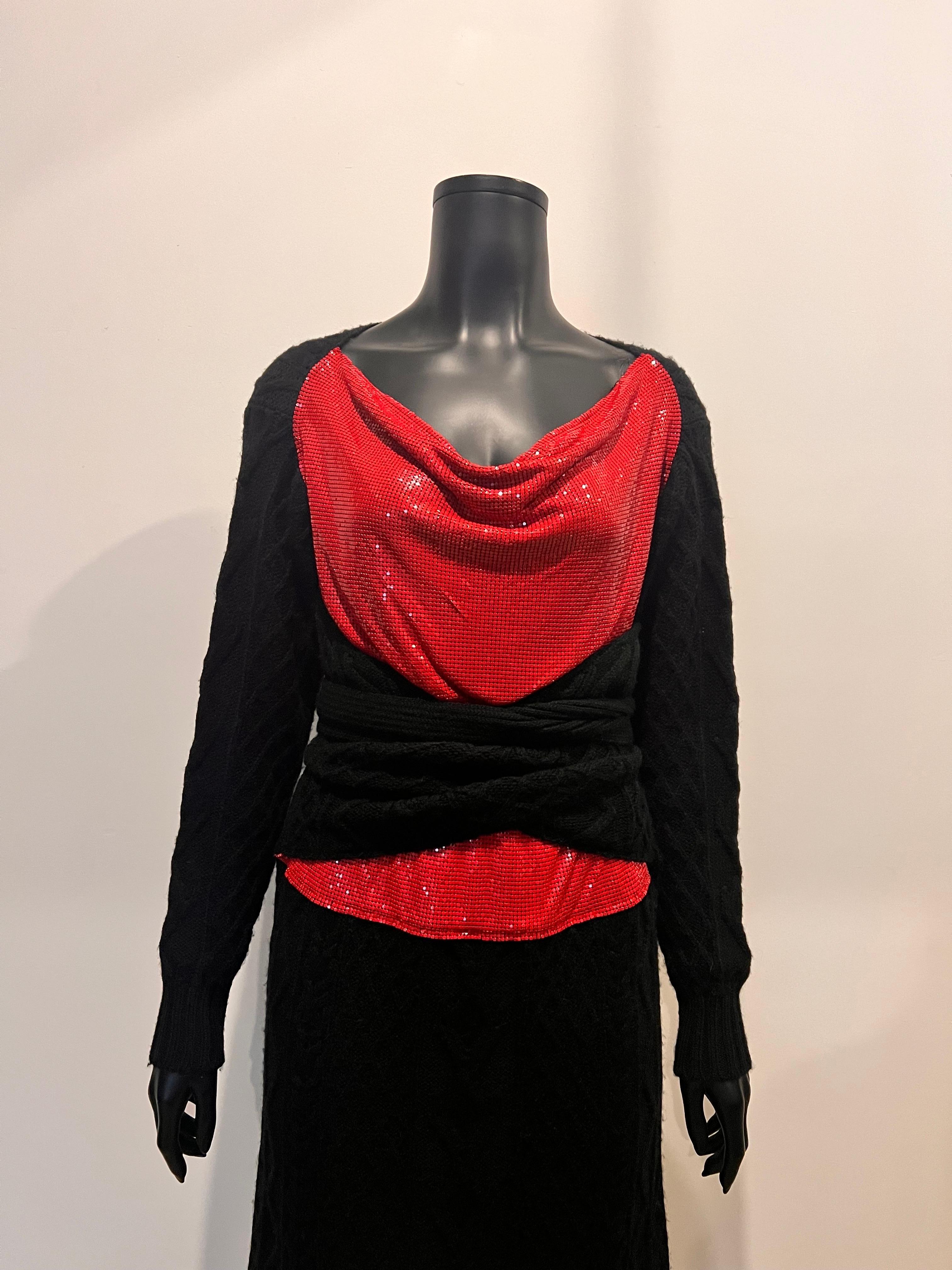 This incredibly unique piece of 1990's Jean Paul Gaultier Maille Femme is an unusual mix of cable knit and glomesh/metal micro sequin style. The dress has exceptionally long wrap ties in the cable knit fabric that wrap twice around the bodice