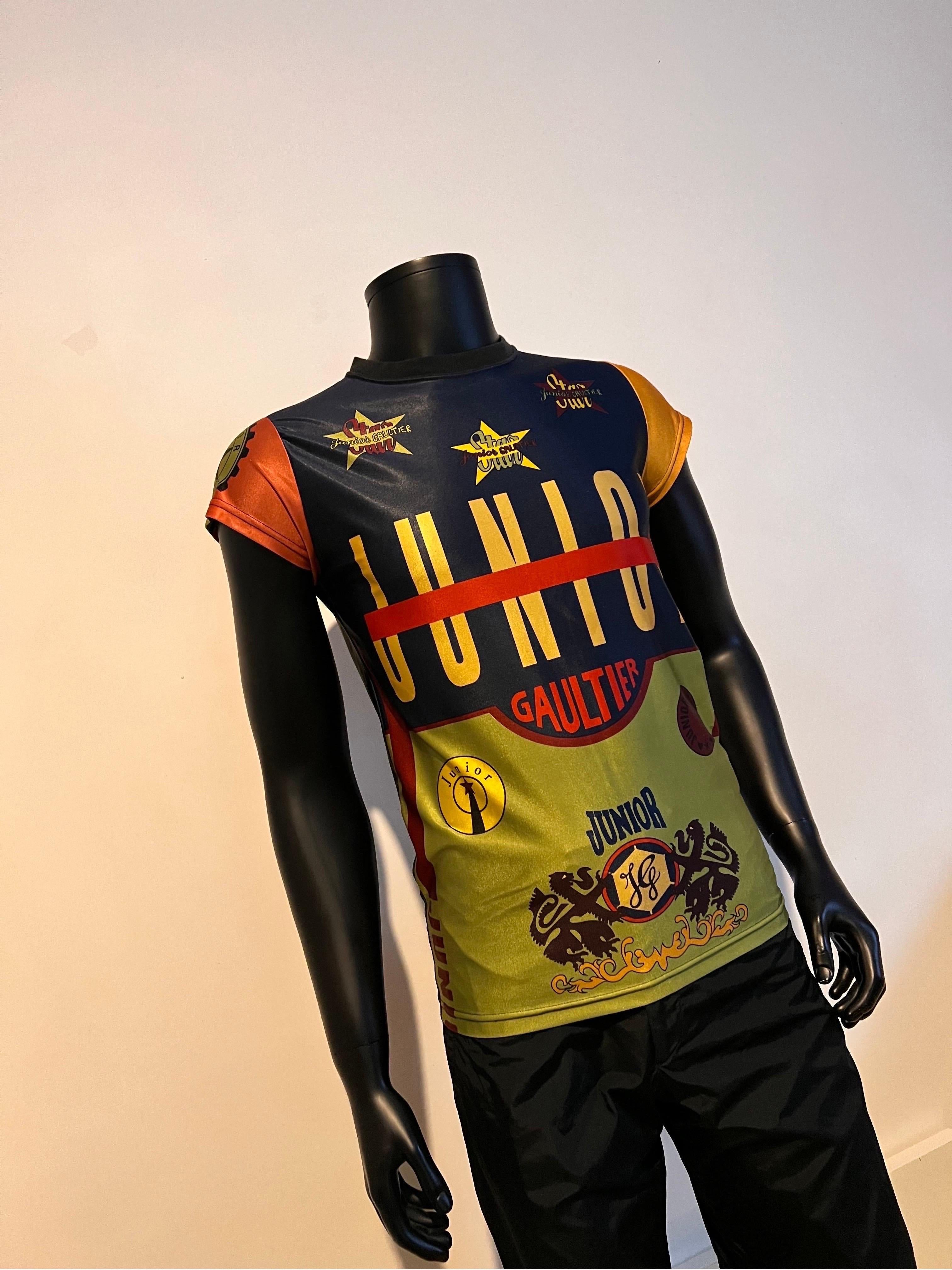 Junior Gaultier by JEAN PAUL GAULTIER vintage iconic multicoloured tee-shirt.

This tee shirt features multicolored graphic blocks with iconic JUNIOR GAULTIER/JPG print.
Ribbed textured round neck, short sleeves, stretch shiny jersey.

This highly