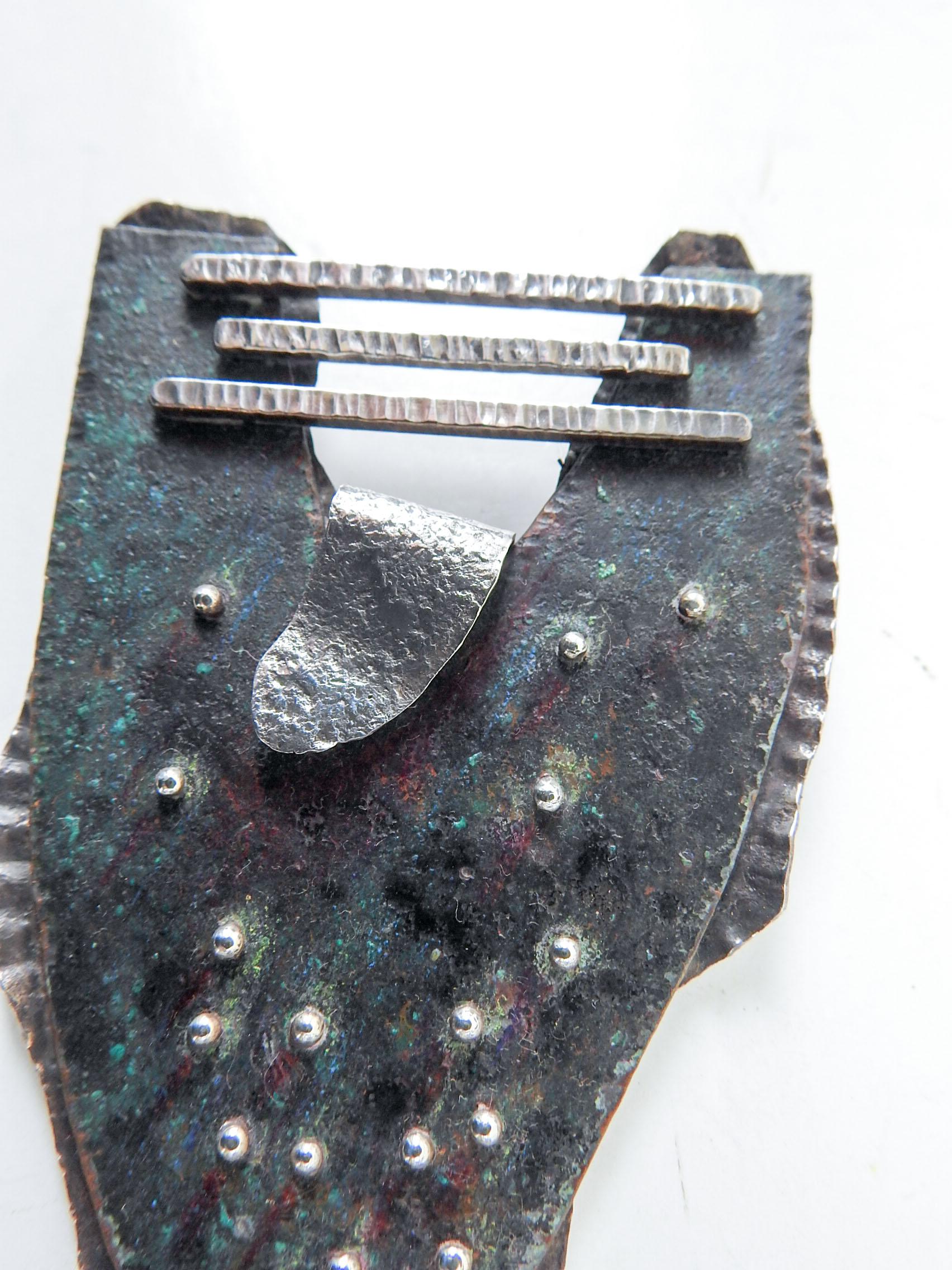 Large sculptural circa 1990's artist made sterling silver and patinated copper brooch. Signed Linda Thompson (20th/21st century). All riveted and hand wrought construction. Dark verdigris textured patina to copper, hammered texture to silver.