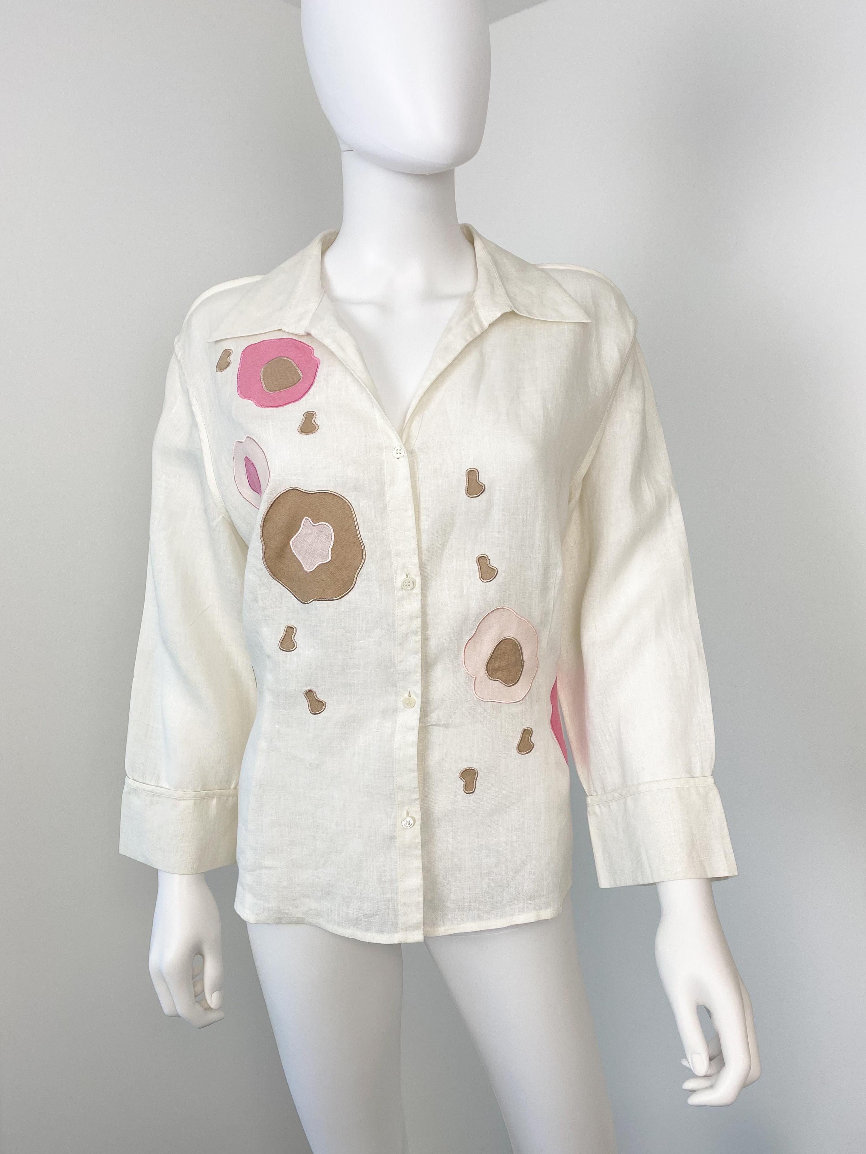 Wonderful vintage Louis Feraud 1990s linen and cotton blouse. Ivory color fabric with powder pink, taupe, and fuchsia pink floral embroidery. 
3/4 sleeves with large open cuff. Slightly fitted cut.

Brand: Louis Feraud
Model: Linen shirt
Material: