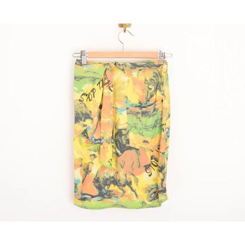 Wonderful Vintage 1990's Moschino wrap skirt in a beautiful yellow ombré colour palette, depicting oil painted artwork with slogan 'Stop the corrida system' in reference to Bull Fighting. 

Features:
Fully adjustable waist line
Two back pockets
100%