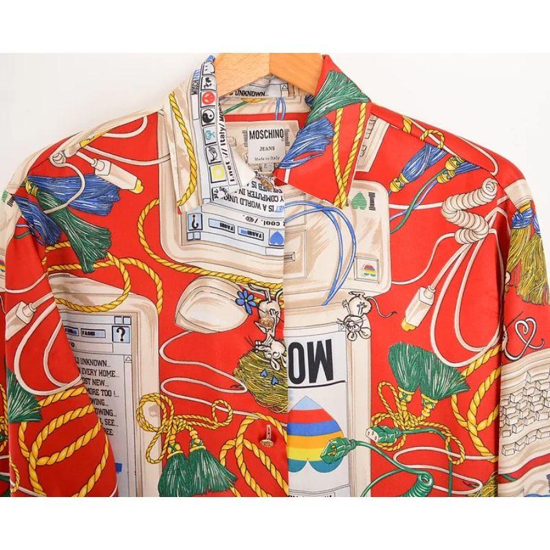 Vintage 1990s Moschino 'Apple Mac' Parody patterned long sleeve shirt, in a red satin feel fabric. 

MADE IN ITALY !

Features:
Central line button fasten
Long sleeves
Loose fit
100% Polyester

Sizing in inches:

Pit to Pit: 23''
Pit to Cuff: