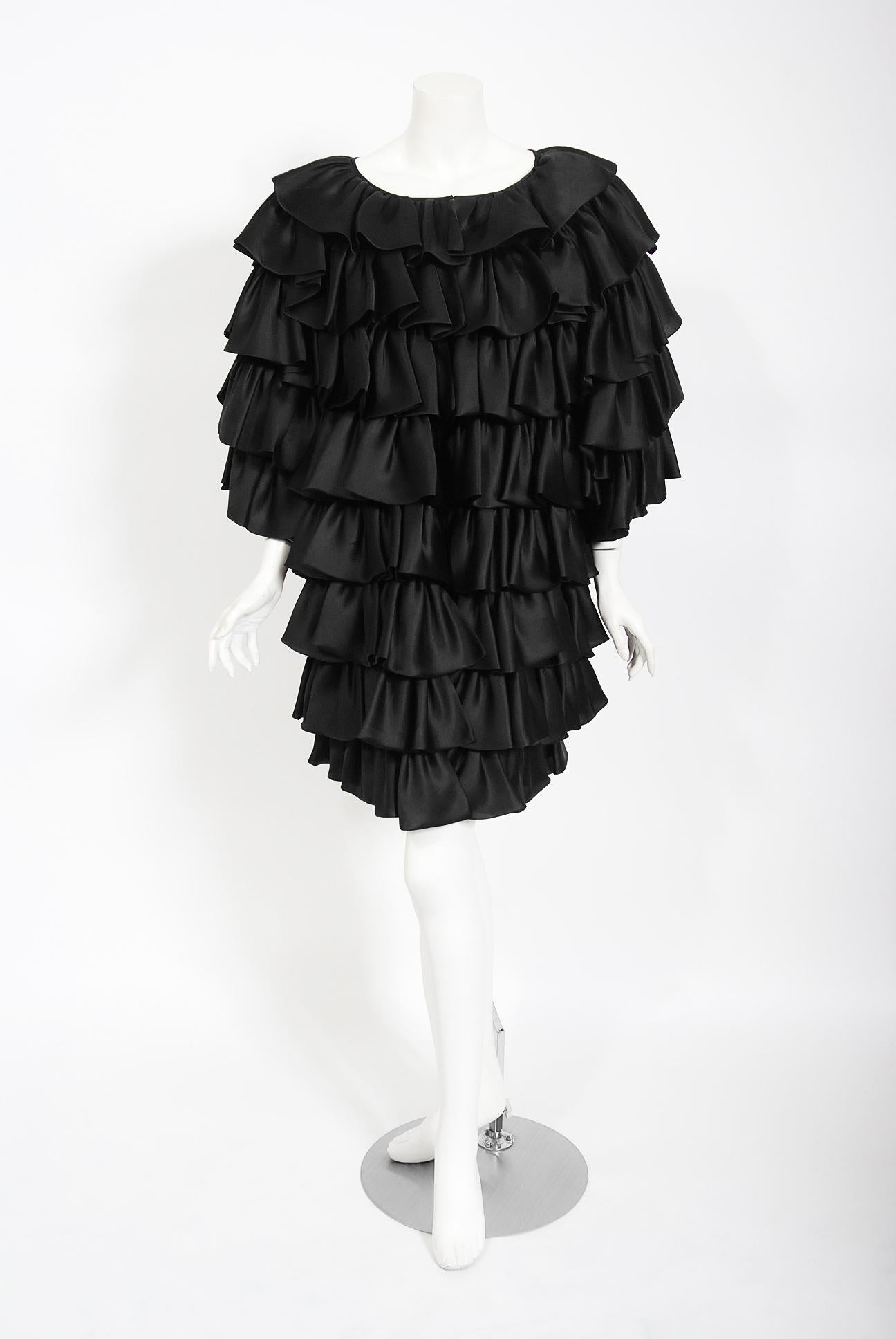 A gorgeous early 1990's Oscar de la Renta black silk tiered-ruffle jacket which cost well over $4,000 when new.   Oscar de la Renta was one of the world's leading fashion designers. Trained by Cristóbal Balenciaga and Antonio Castillo, he became
