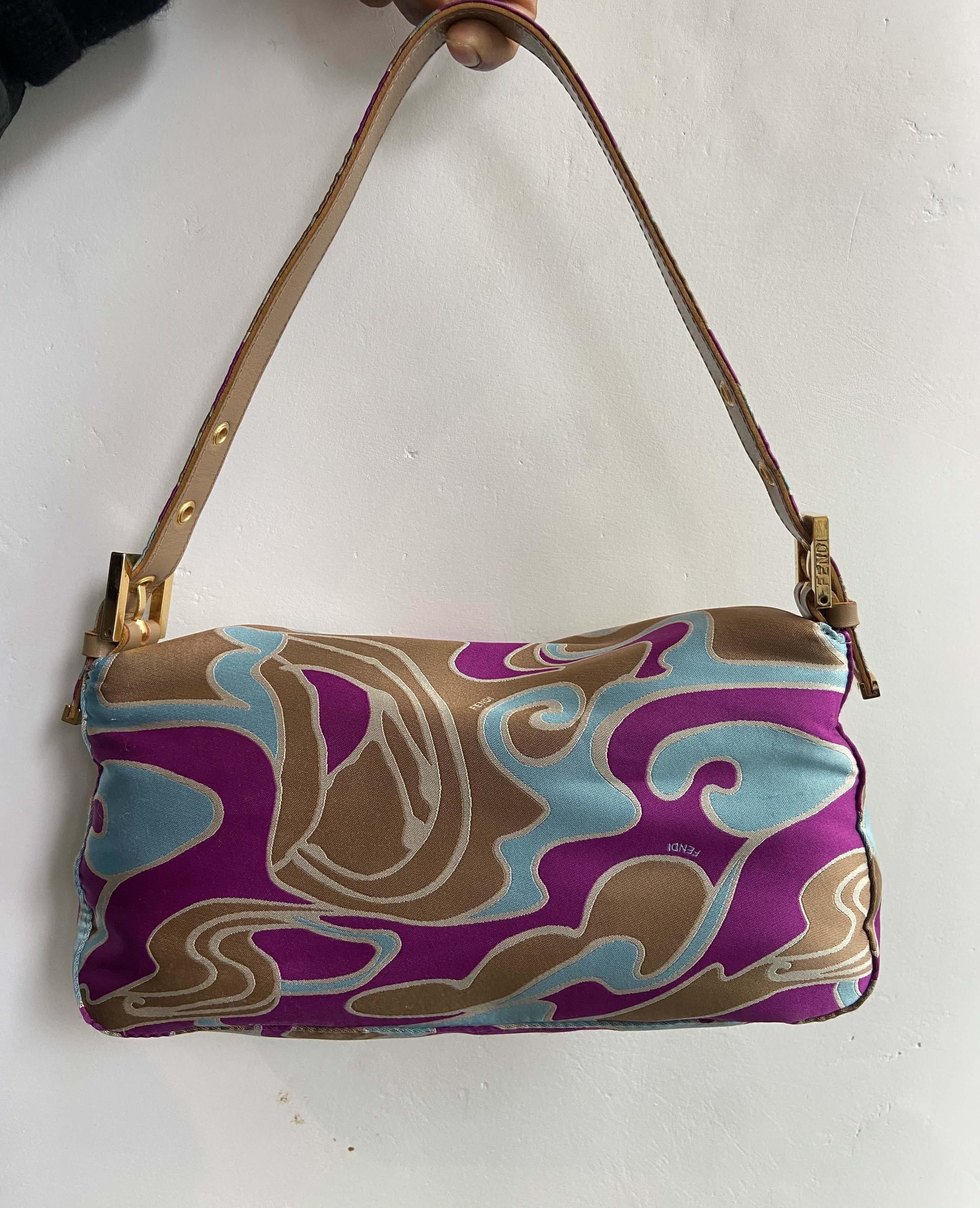 Vintage Fendi late 1990’s shoulder baguette bag. Features the rare psychedelic swirl print in a satin fabric, adjustable leather and satin  strap with Fendi branded hardware buckles, iconic Fendi satin and metal front flap with magnetic closure and