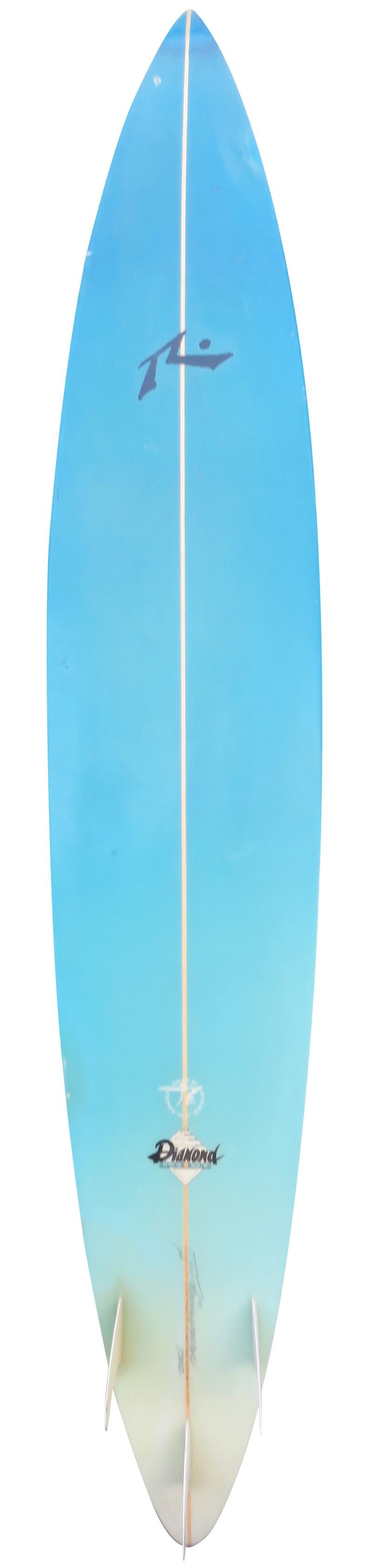 Vintage 1992 Rusty big wave surfboard shaped by Rusty Preisendorfer. Features a sky blue airbrush fade done by Stephen Scatolini and glassed on thruster (tri-fin) setup. This vintage surfboard remains in all original condition. 

Rusty