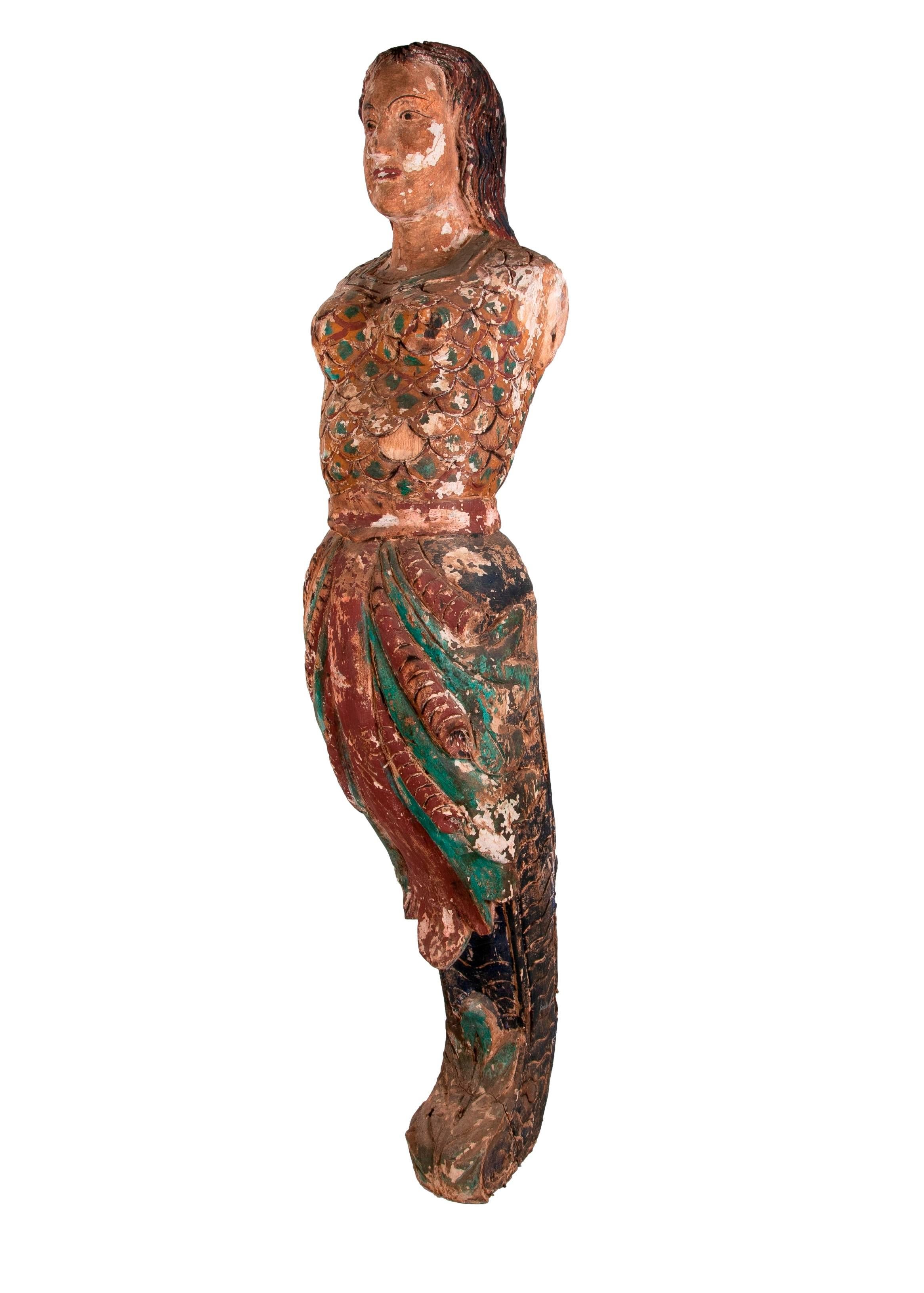 Vintage 1990s Spanish hand carved wooden painted mermaidsculpture, reminiscent of a boats figurehead.