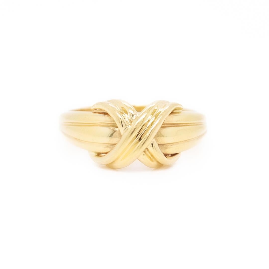 A very fine vintage 'X' ring.

By Tiffany & Co.

In 18k yellow gold.

Simply classic design by Tiffany & Co.!

Date:
1990s

Overall Condition:
It is in overall good, as-pictured, used estate condition with some fine & light surface scratches and