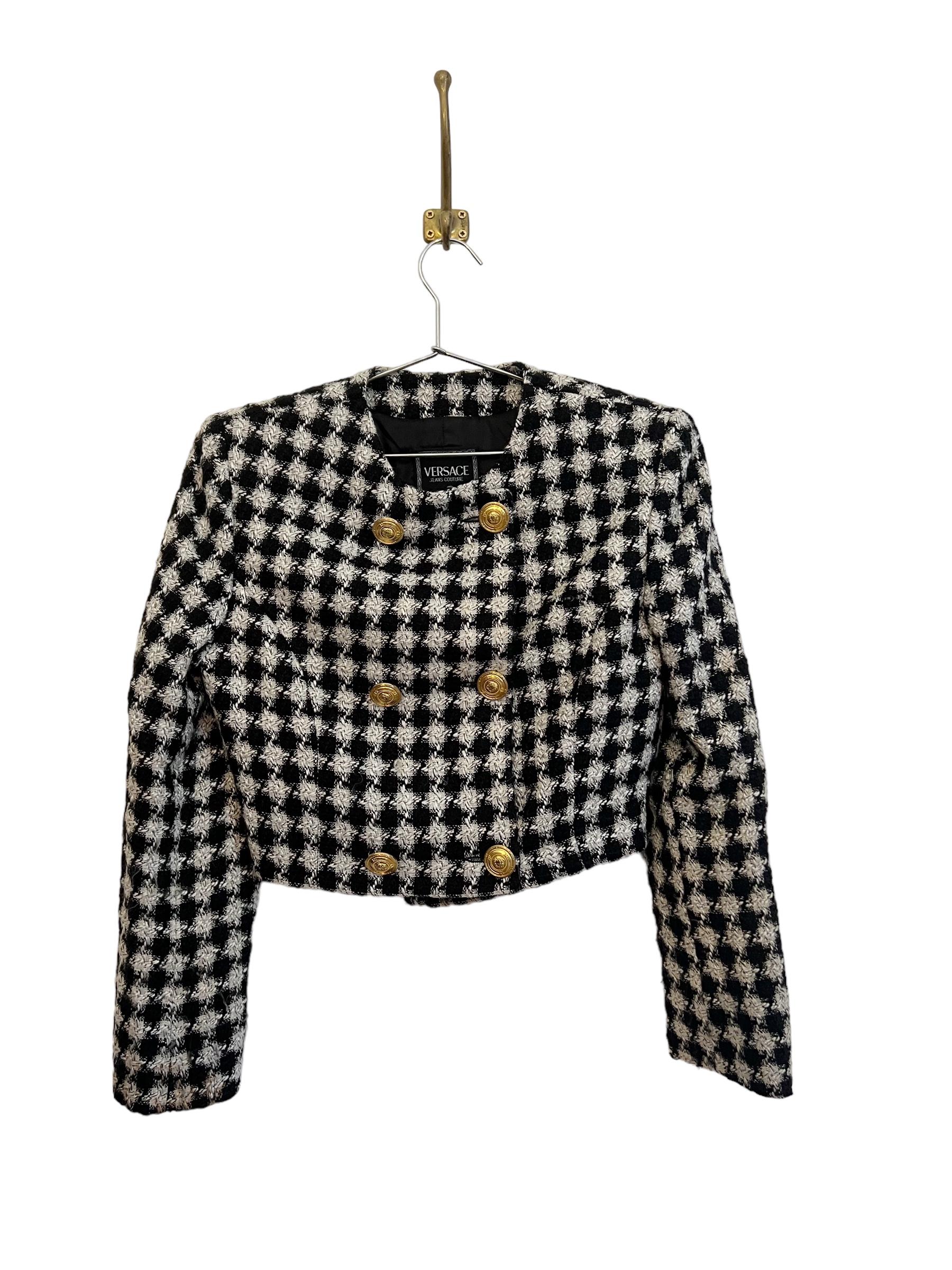 Chic Vintage early 1990's Versace Jeans Couture Matching shift Mini Dress and Cropped Tweed boucle jacket, in a houndstooth textured material with Gold metal hardware and iconic Medusa details.  

Jacket Features:  
Buttons down front 
Black fully