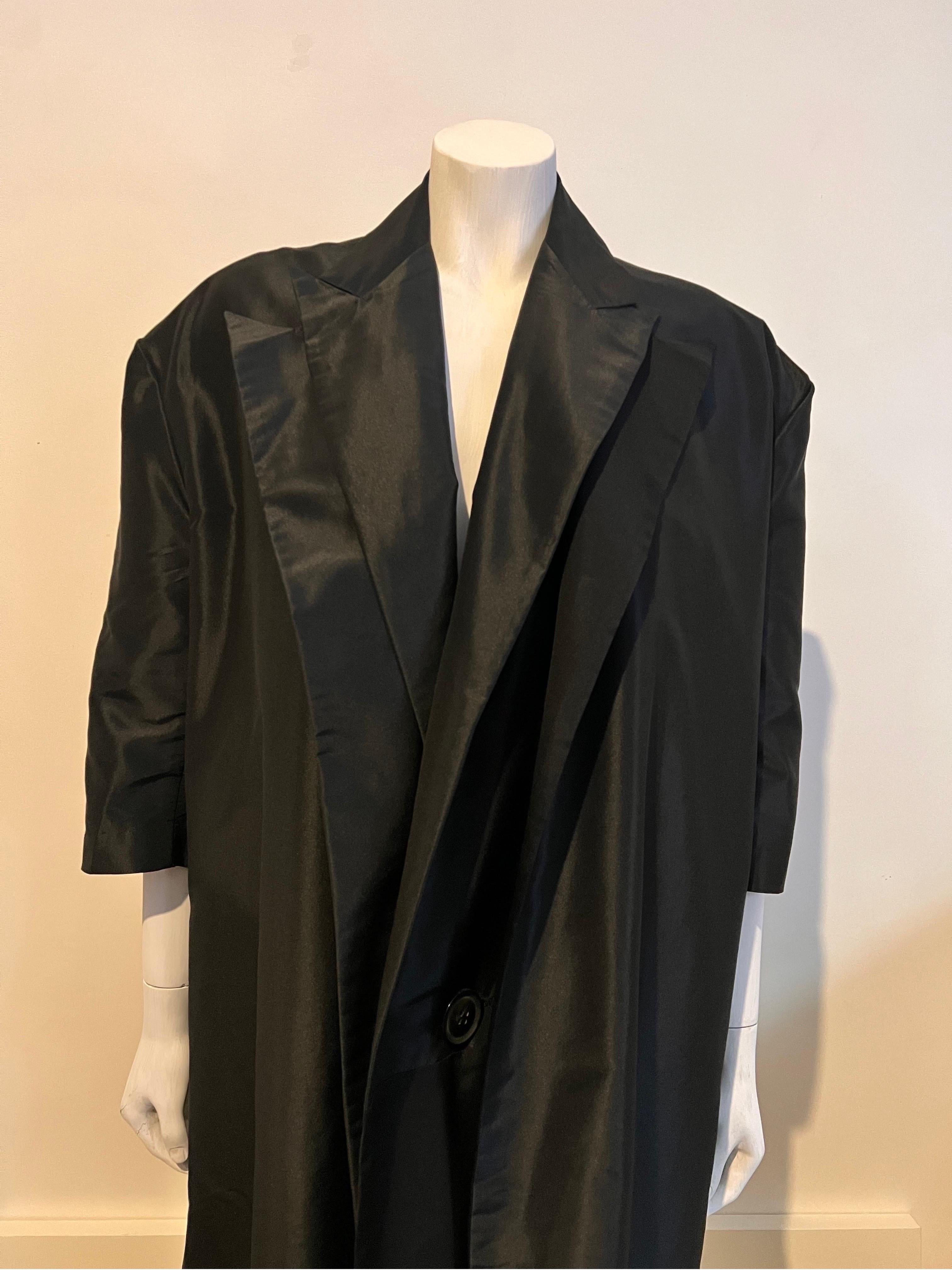 A very chic oversized vintage 1990's Yohji Yamamoto evening coat with a very unique cut and  shape.

The piece is cut double the length of the garment and turned back on it self with the finished coat showing a double layer of the lapels at the