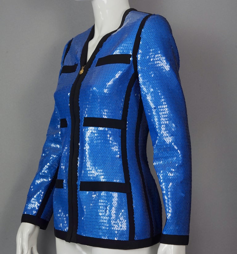 Vintage 1991 CHANEL Blue Sequin Scuba Jacket
From 1991 Collection, VOGUE cover.

Measurements taken laid flat, please double bust, waist and hips:
Shoulder: 14.96 inches (38 cm)
Sleeves: 23.22 inches (59 cm)
Bust: 16.14 inches (41 cm)
Waist: 14.96