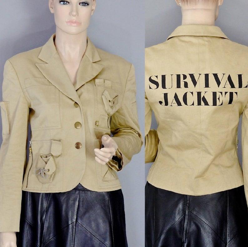 Vintage 1991 MOSCHINO COUTURE Survival Jacket Military Safari Khaki Jacket

Measurements taken laid flat, please double bust and waist:
Shoulder: 17.12 inches (43.5 cm)
Sleeves: 22.24 inches (56.5 cm)
Bust: 17 inches (43.18 cm)
Waist: 16 inches