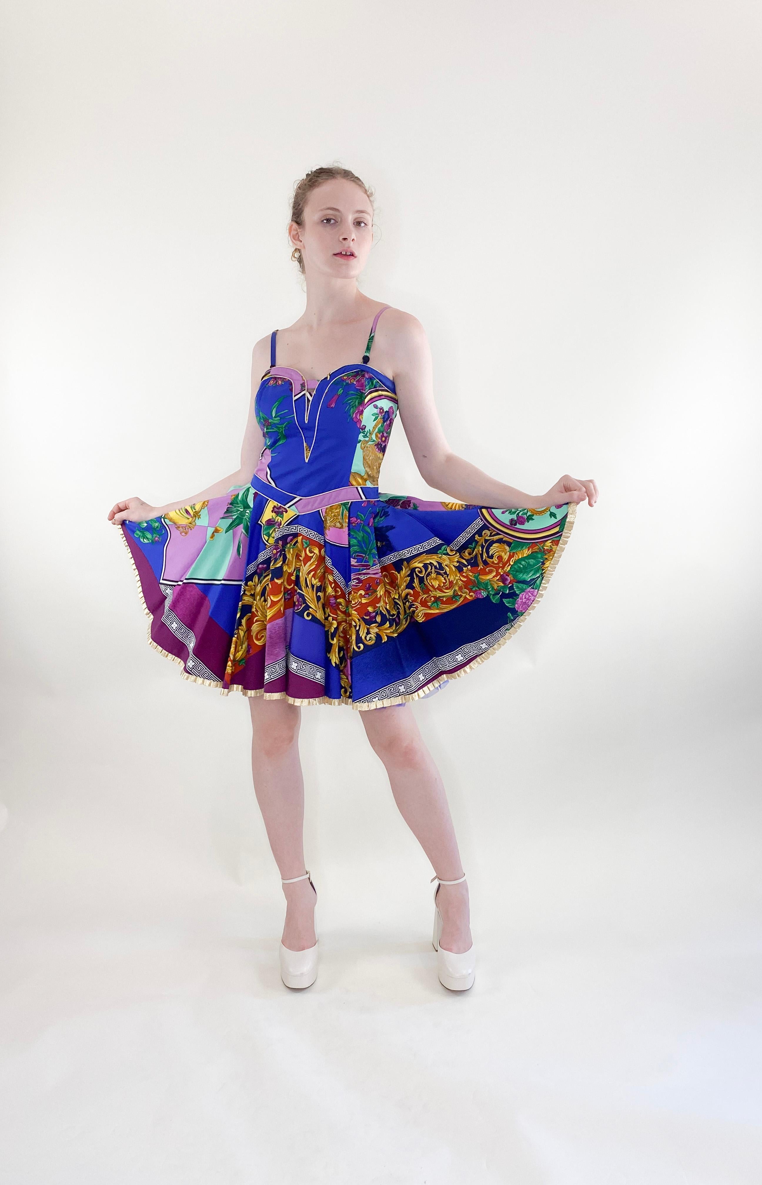 This Versace Jeans Couture Cotton Baroque 1992 spring dress features a full skirt, cropped denim overtop, and a soft mix of baroque and flower designs. With a hint of pinup girl attitude, this mini dress exudes sexiness and showcases the exceptional
