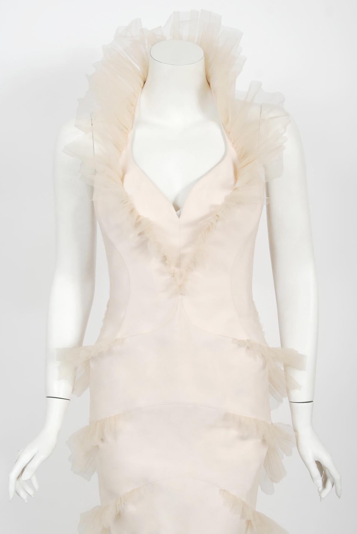 An absolutely breathtaking and highly coveted Thierry Mugler couture cream stretch-silk bustier hourglass tiered tulle gown dating back to his spring-summer 1992 collection. This legendary French fashion designer is known for bold fashion and edgy,