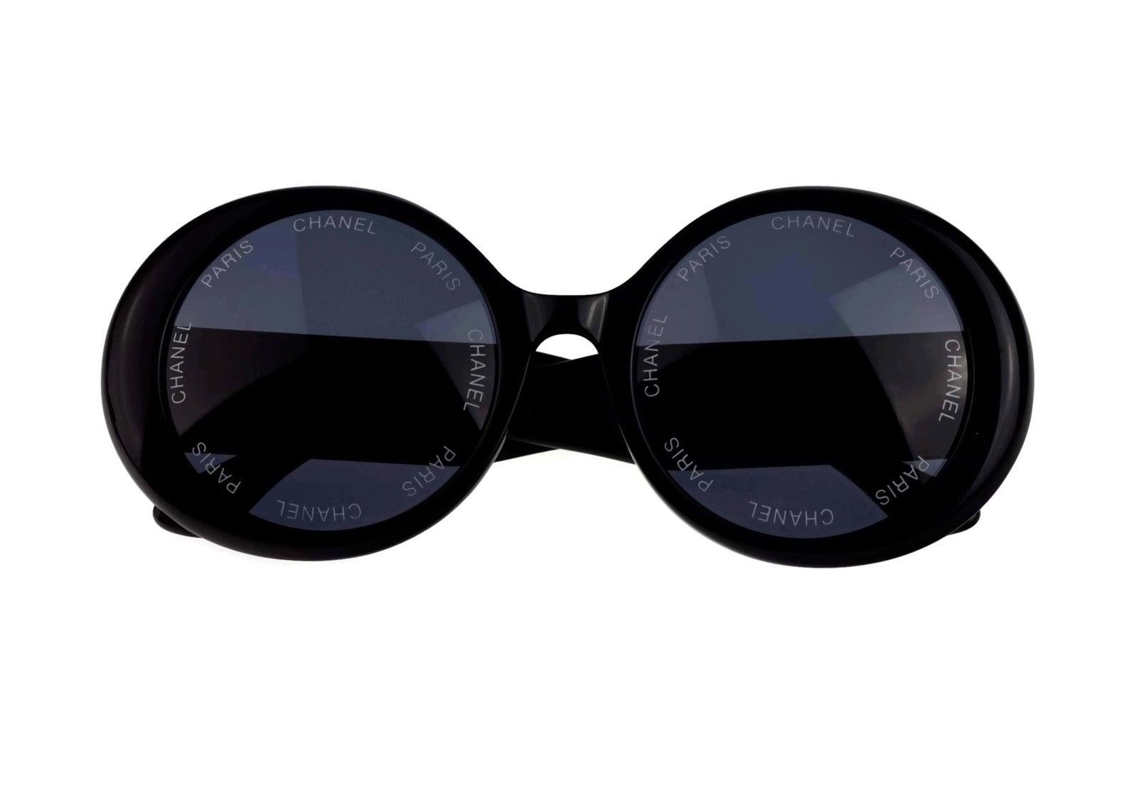 Vintage 1993 Iconic CHANEL PARIS Lens Round Black Sunglasses As Seen On Rihana

Measurements:
Height: 2.36 inches (6 cm)
Frame Width: 5.70 inches (14.5 cm)
Temples: 5.23 inches (13.3 cm)

As seen on Rihanna.
From CHANEL Spring/ Summer 1993