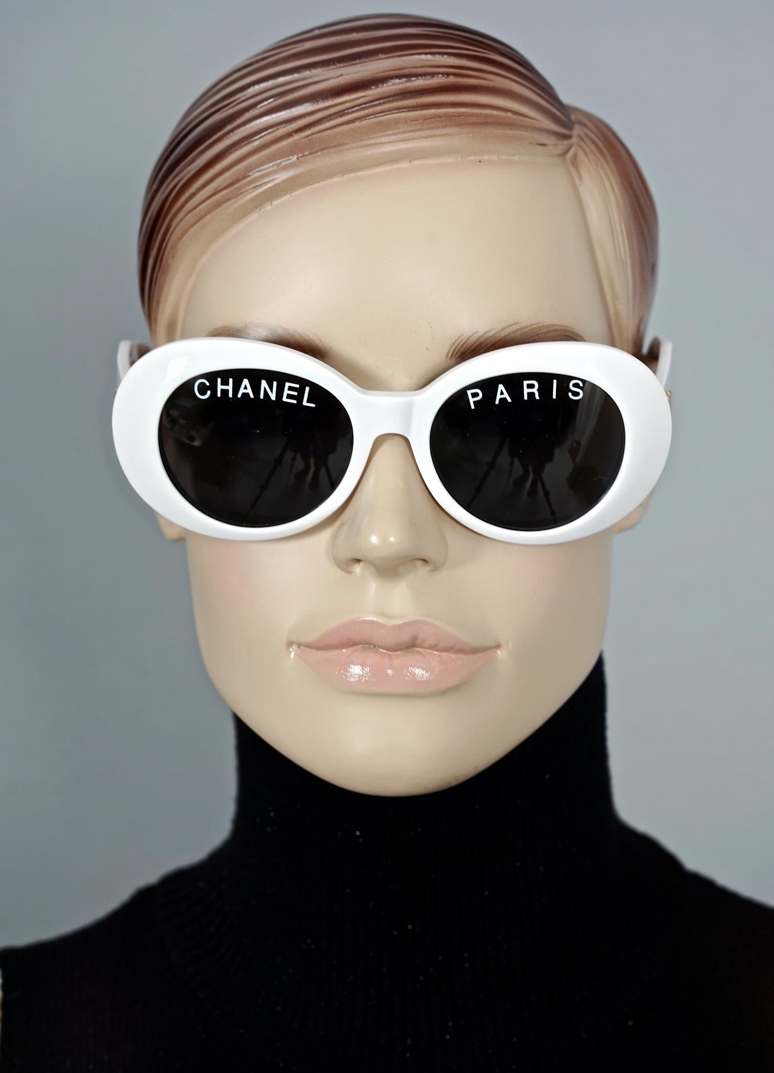 Vintage 1993 Iconic CHANEL PARIS Spelled White Sunglasses

Measurements:
Height: 2.12 inches (5.4 cm)
Frame Width: 5.51 inches (14 cm)
Temples: 5.11 inches (13 cm)

As seen on Pharrell Williams.
From CHANEL Spring/ Summer 1993