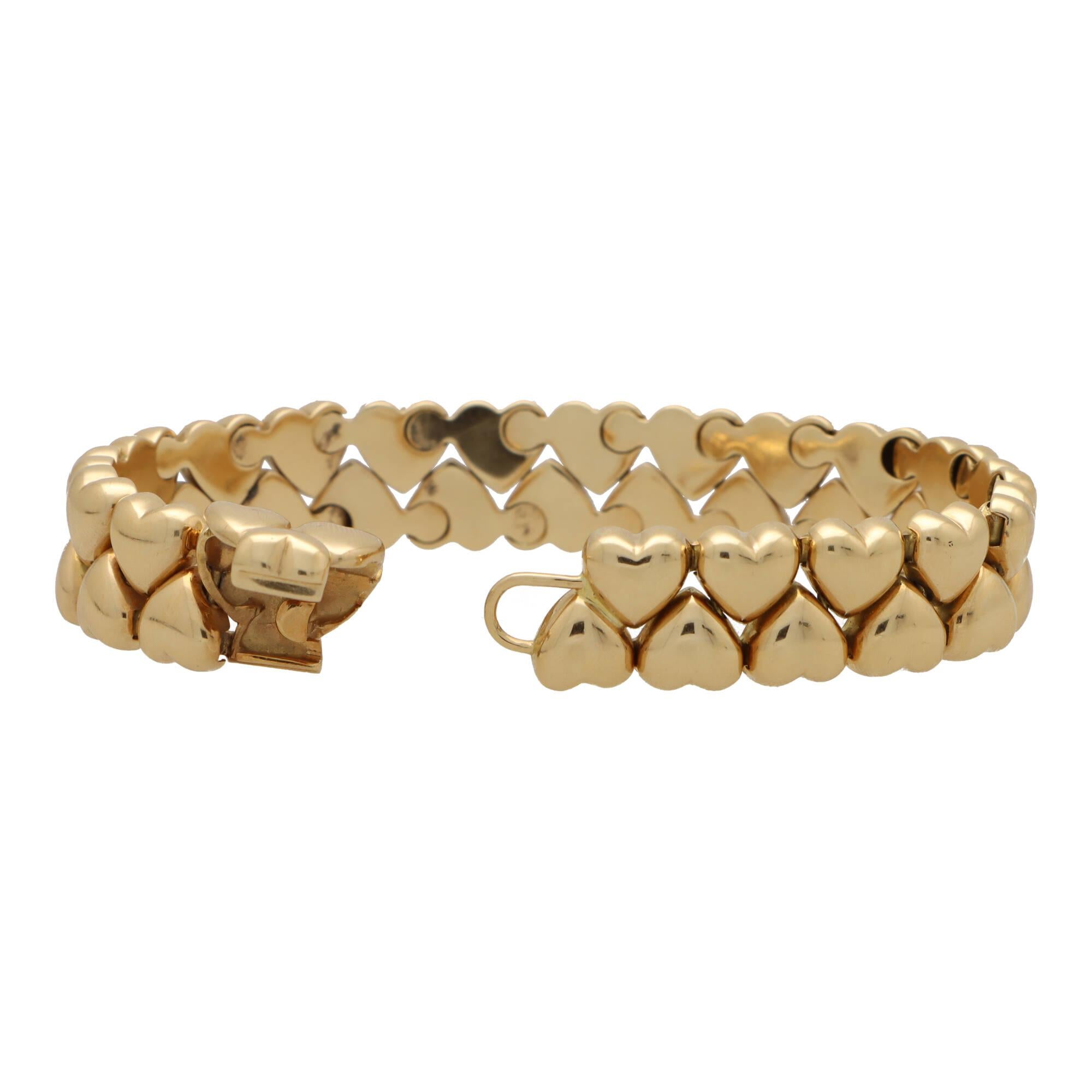 A beautiful vintage Cartier double heart bracelet set in 18k yellow gold.

From the now discontinued Cartier Heart collection, the bracelet is composed of 2 rows of heart motifs, connected by an articulated setting. Every heart is polished yellow