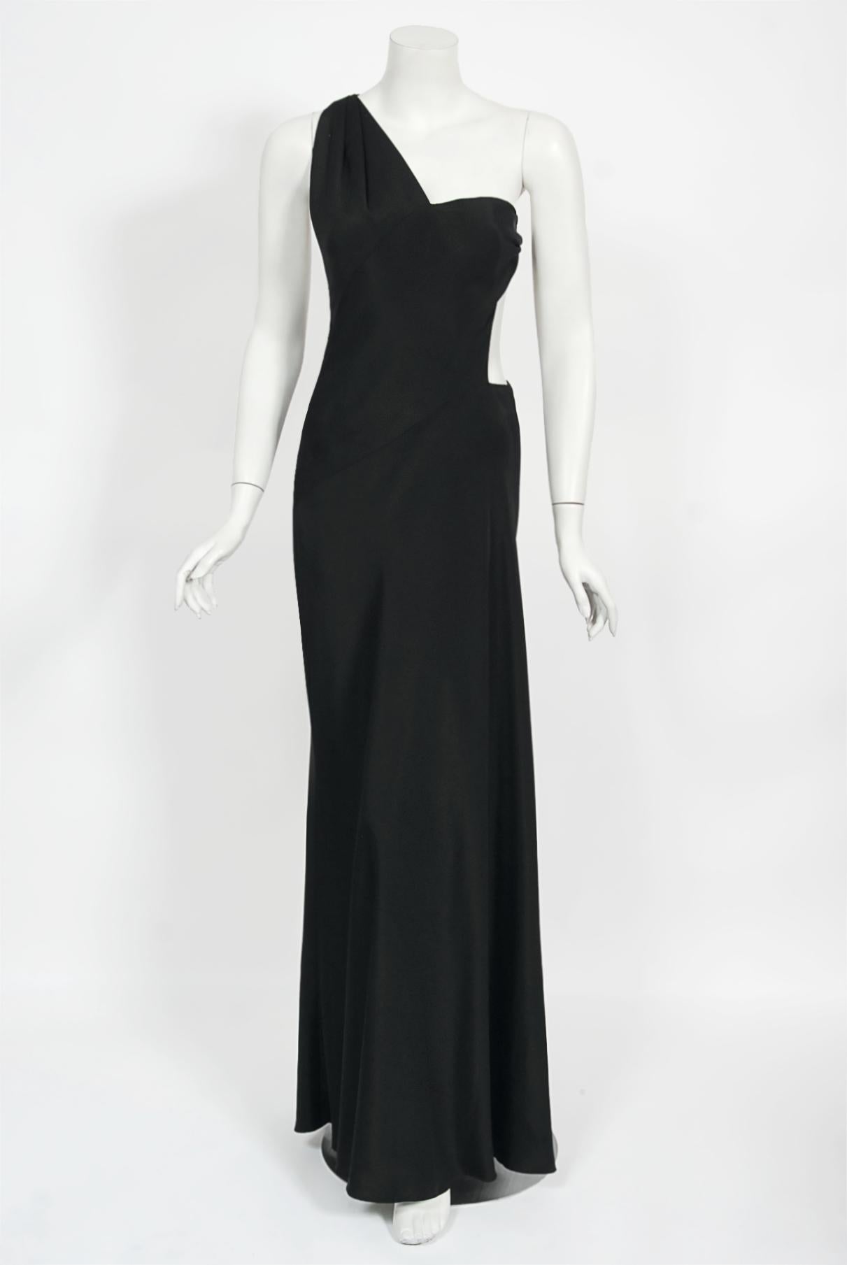 An ultra chic and super seductive Philippe Venet haute couture black silk sculpted cut-out gown dating back to his 1994 spring-summer runway collection. This is also a very special dress because it comes from his very last collection. Venet famously