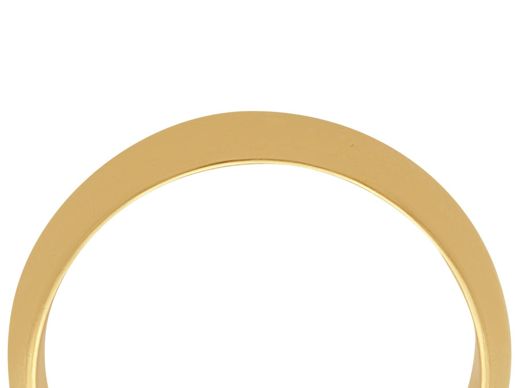 A fine and impressive vintage English 9 karat yellow gold gent's wedding ring; an addition to our vintage jewelry and estate jewelry collections.

This impressive gentlemen's vintage wedding ring has been crafted in 9k yellow gold.

The substantial