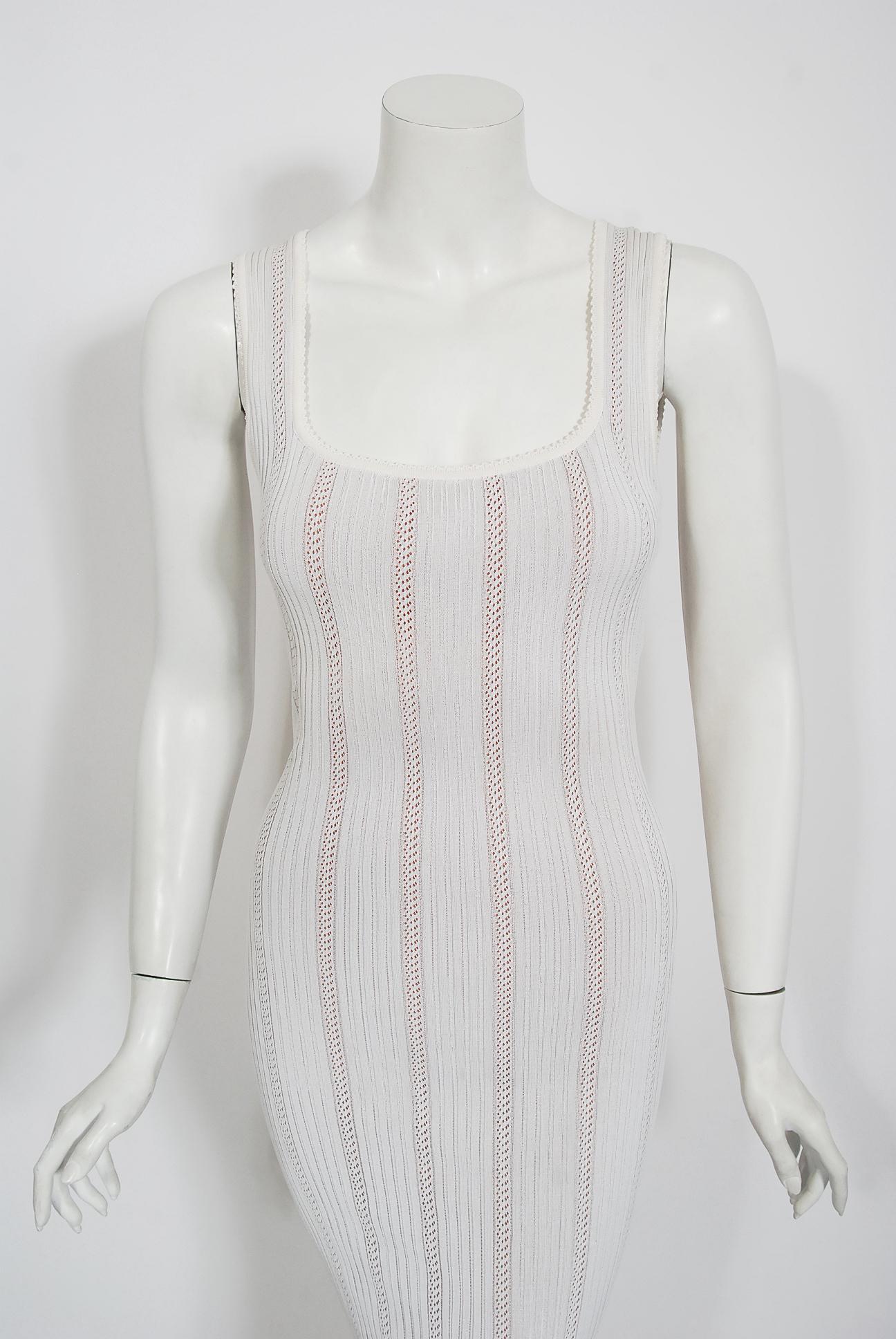Iconic white patterned knit floor-length documented gown from Azzedine Alaia's 1996 Spring/Summer collection. In the 1980's when most of the fashion world was embracing sharp shouldered power dressing and baggy androgyny, Alaïa introduced the world