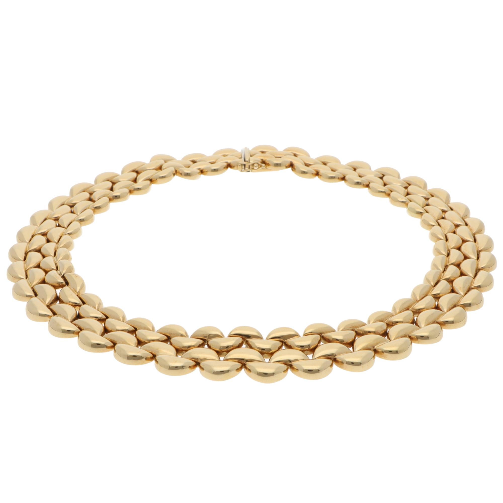 A beautiful vintage Cartier fancy link necklace set in 18k yellow gold from 1996.

The necklace is composed of solid yellow gold half-circle links connected all around the neck. This particular design is the four-row necklace, which stands out