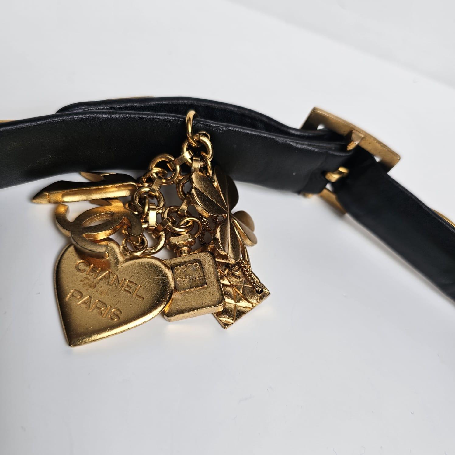 Vintage 1996 charms black leather belt in size 80. Good vintage condition, with scratches on the leather surface and slight bending on the leather. Some area shows minor splitting but not significant. Scuffing and marks on the hardware details. Belt