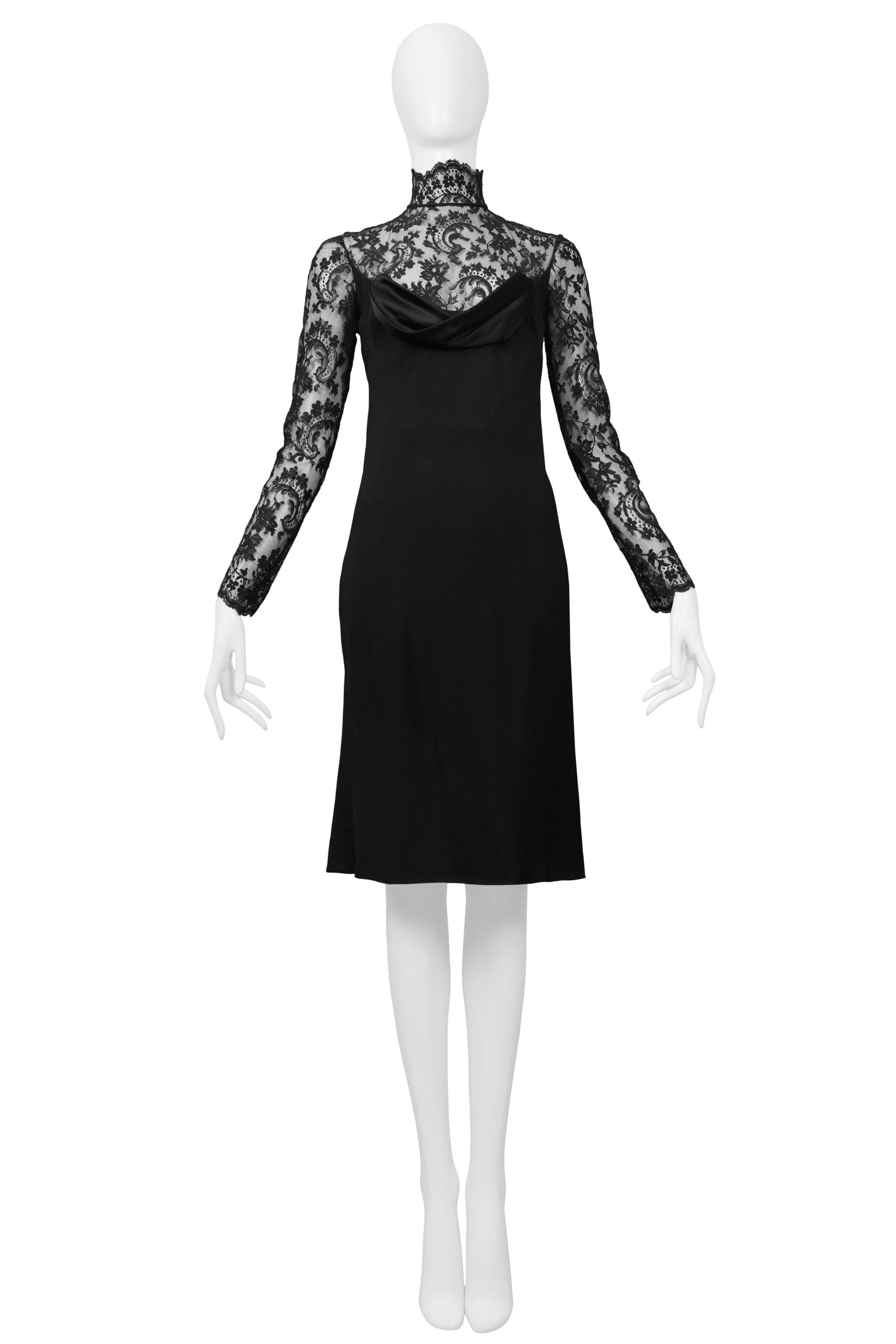 Resurrection is excited to offer a vintage Givenchy by John Galliano black lace cocktail dress featuring long sleeves, a mock neck, silk covered button & zipper closure at back, and a black silk overlay with draped neckline and open back.

Givenchy