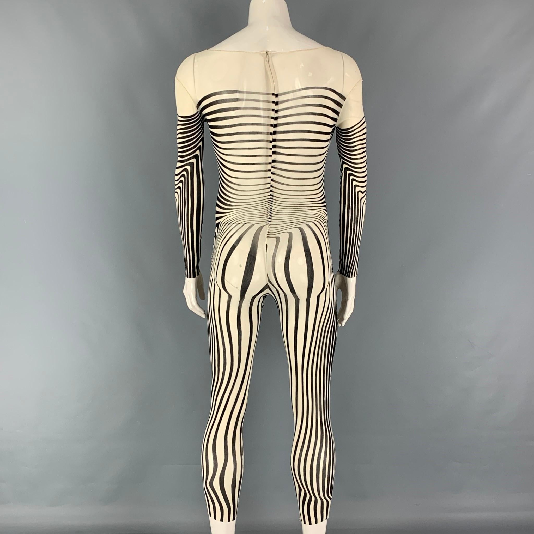 Vintage 1996 JEAN PAUL GAULTIER body suit comes in a stretch cream & black see through print polyamide featuring a scoop neckline and a back zip up closure. Logo tag removed.

Very Good Pre-Owned Condition. Fabric tag removed.
Marked: Size tag