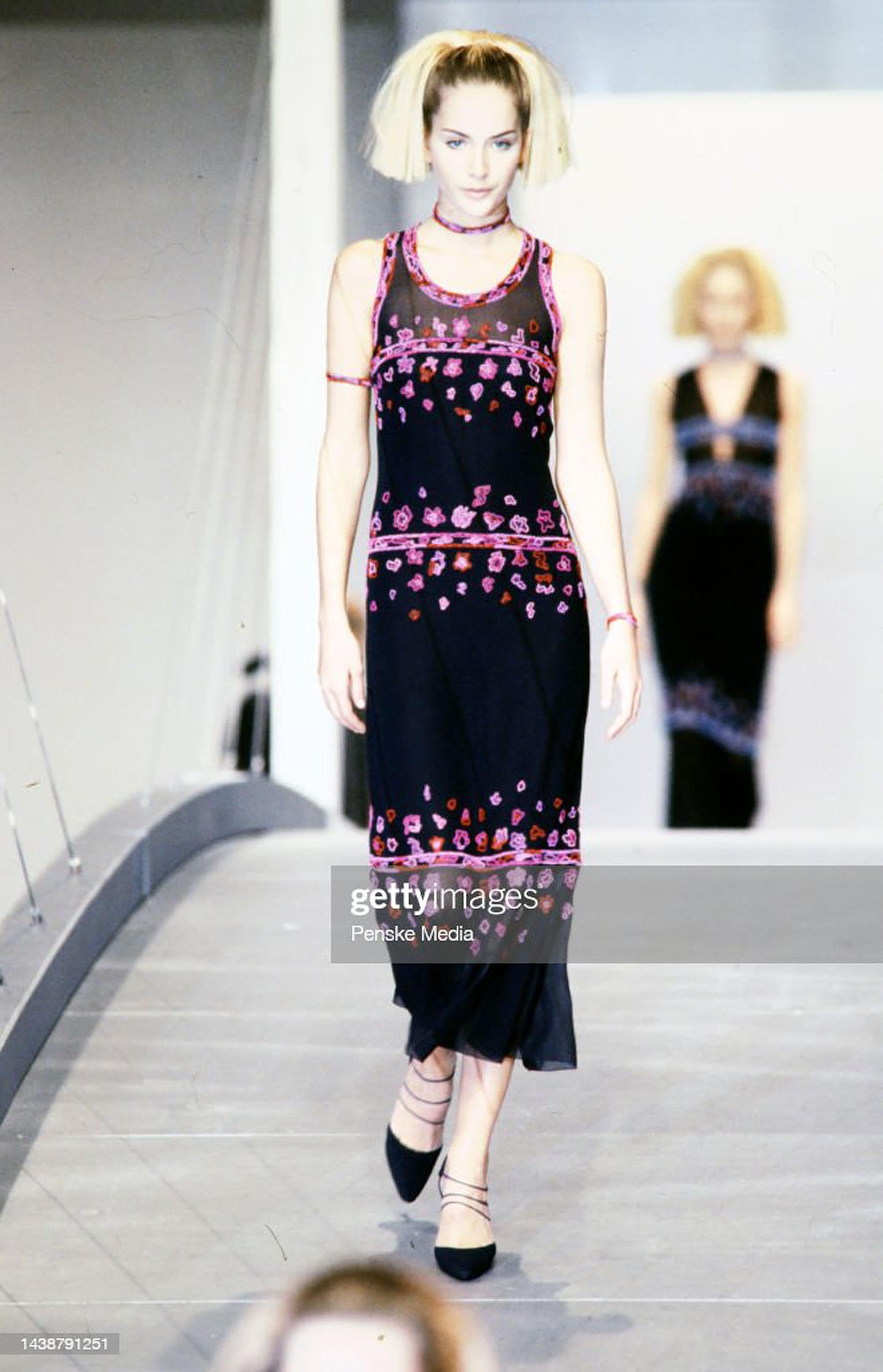 Chanel is known to be one of the most luxurious and decadent fashion houses in the world. This sensational dark midnight blue heavily beaded semi-sheer silk chiffon dress, dating back to Karl Lagerfeld's unforgettable 1997 fall-winter runway