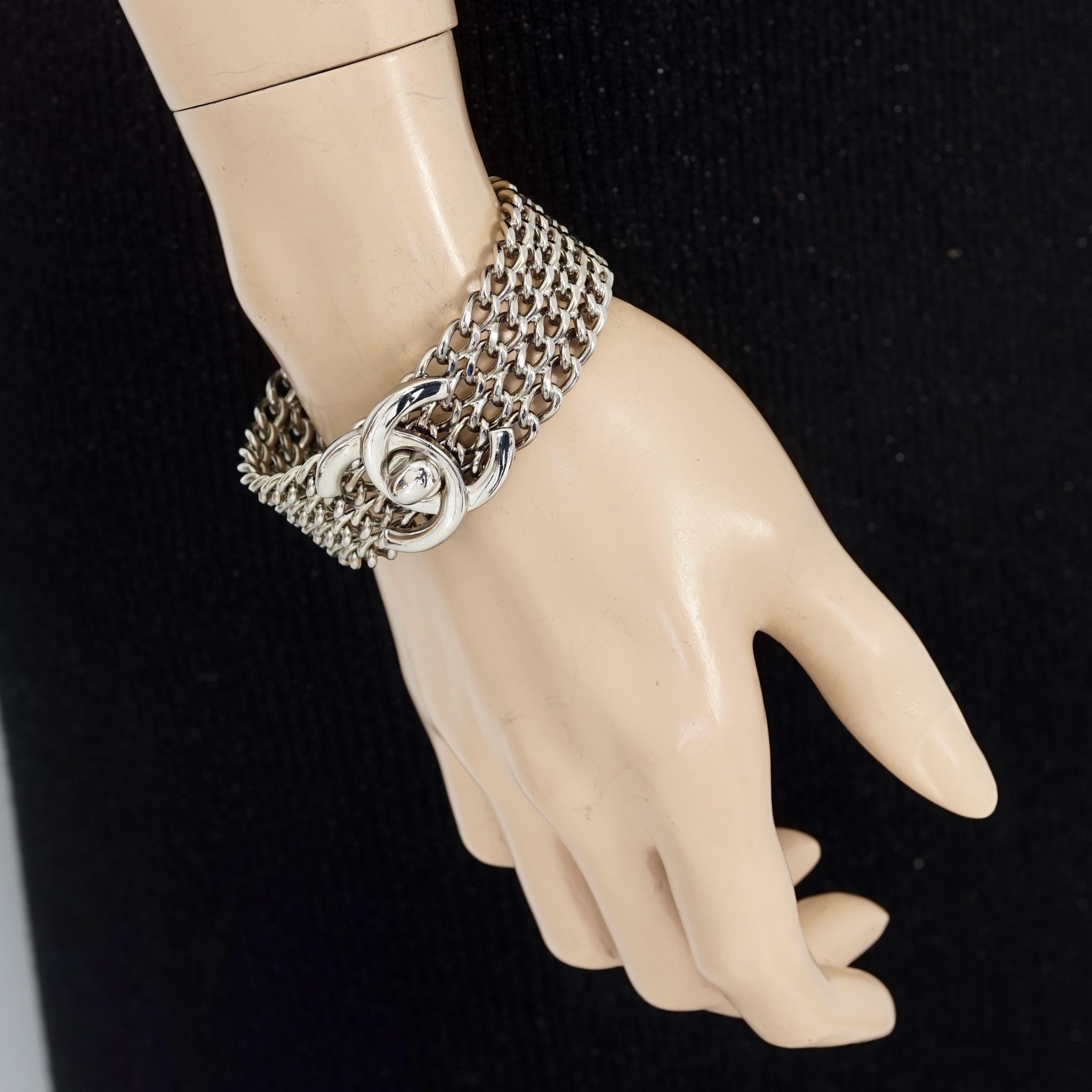 Vintage 1997 CHANEL CC Turnlock Multi Chain Cuff Bracelet

Measurements:
Height: 0.98 inch (2.5 cm)
Wearable Length: 7 inches (17.8 cm)

Features:
- 100% Authentic CHANEL.
- Rigid multi chain cuff bracelet with CC turnlock.
- Signed CHANEL 97 CC A