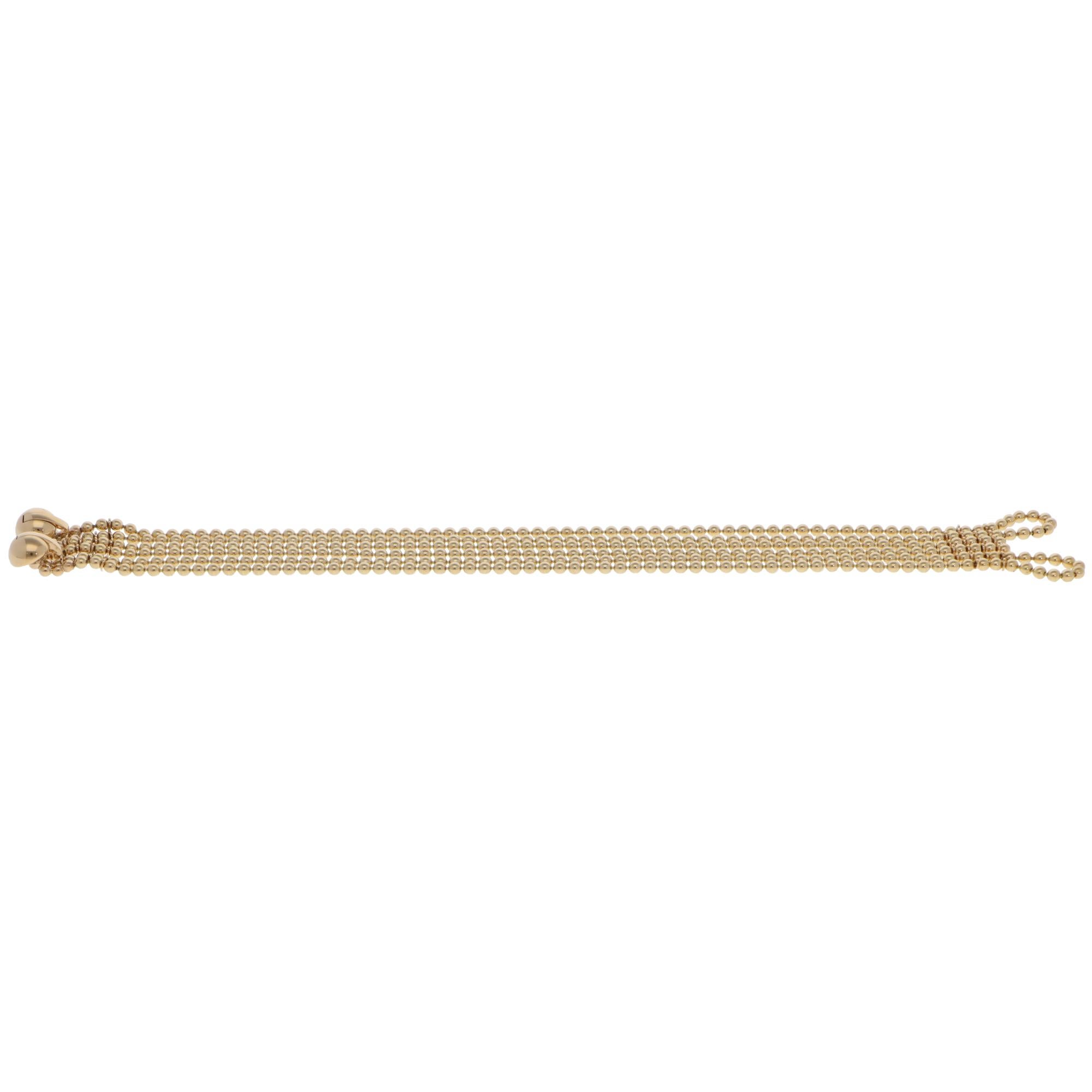 A beautiful vintage Cartier Draperie bead link bracelet set in 18k yellow gold from 1999.

From Cartier's discontinued collection, the bracelet is composed of six rows of solid yellow gold bead links that stand out beautifully on the wrist. The