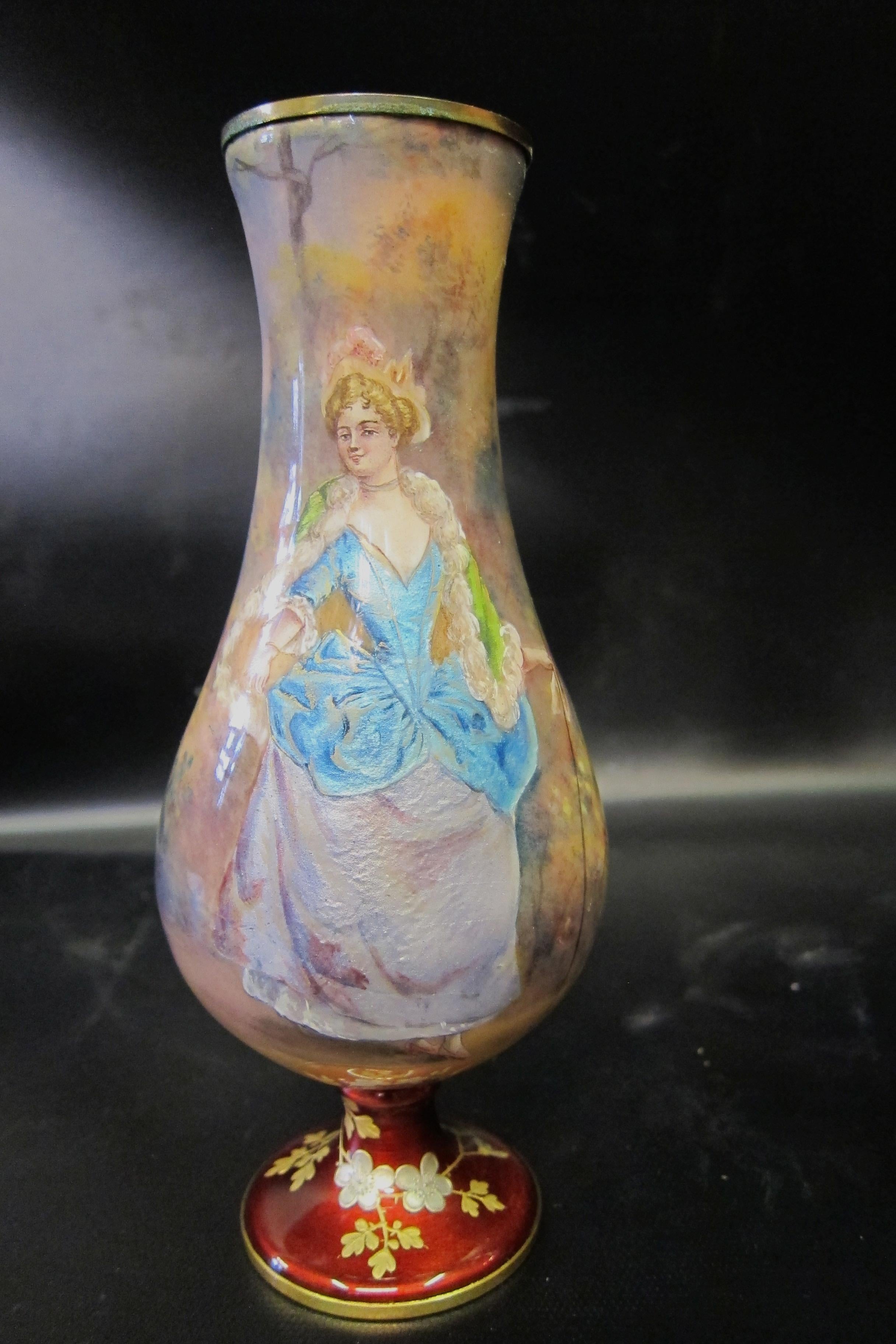 An exceptional vintage pair of hand painted French/Austrian enamel vases that are artist-signed & designed in the 19th century. The vases display detailed and elaborately costumed full figured aristocrats. The artist, Roiby, using vivid luminescent