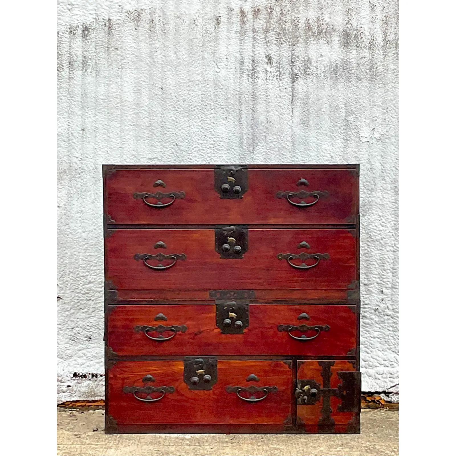 A striking vintage pair of stacking Asian chests. The iconic Tansu cabinet with lots is great heavy hardware. Gorgeous as separate nightstand or stack them for a gorgeous chest of drawers. Acquired from a Palm Beach estate.