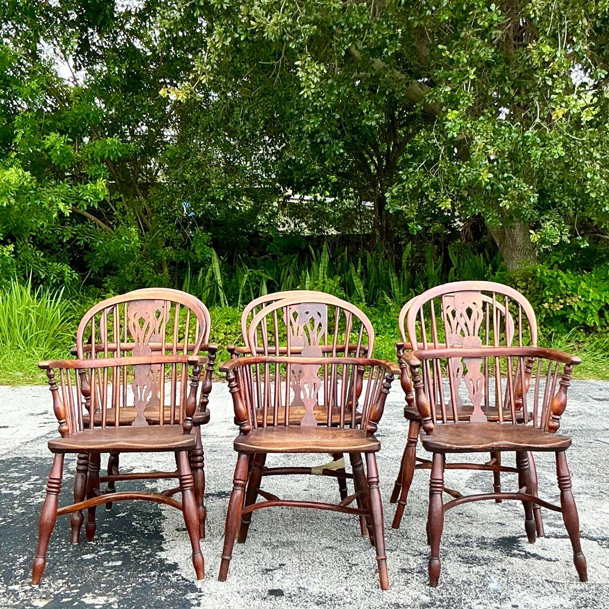 Fai un salto indietro nel tempo con queste squisite sedie Windsor inglesi vintage del XIX secolo. Ogni sedia è caratterizzata da un'artigianalità senza tempo, con fusi elegantemente curvati e una seduta sagomata per garantire comfort e stile. La