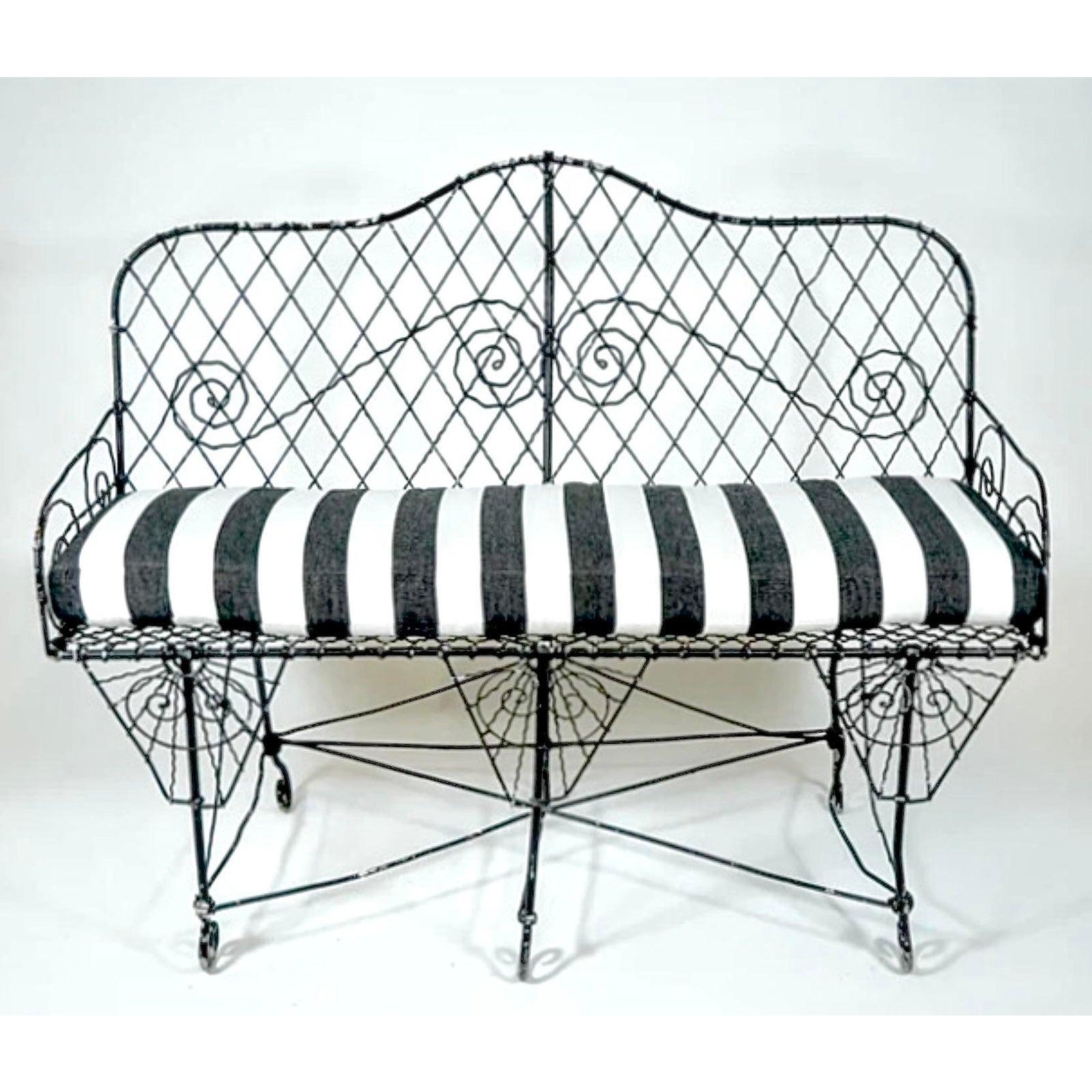 A fabulous vintage French wire garden bench. A beautiful 19th century Art Nouveau piece with incredible wire work. New cabana striped cushion for extra glamour. Acquired from a Palm Beach estate.

The bench is in great structural condition. Scuffs
