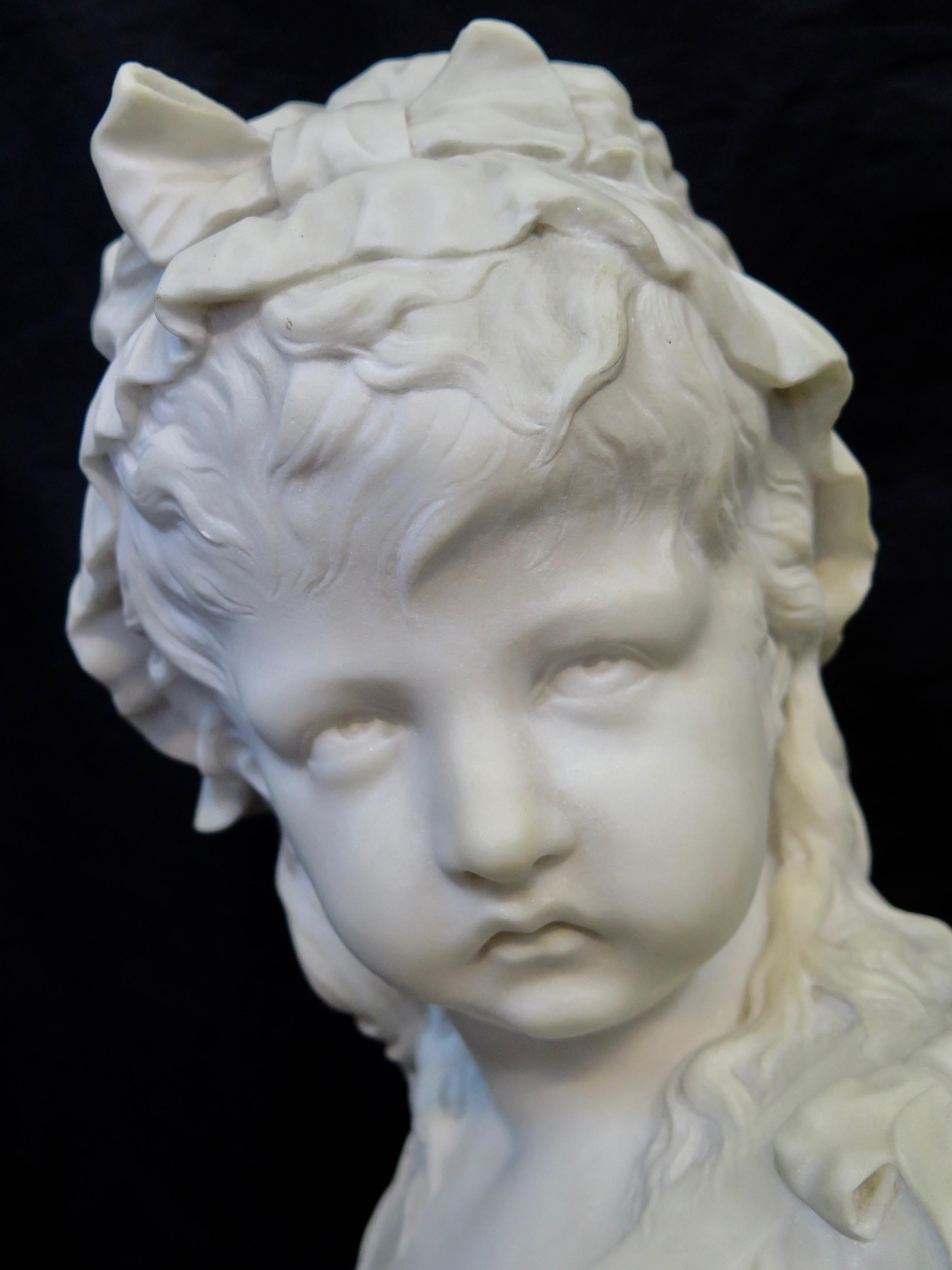 This vintage 19th century marble sculpture depicts the bust of a young French girl. The artist seems to be showcasing the anguish of the French Revolution through the eyes of this young innocent victim. The artist, Joseph Nelson's depiction is