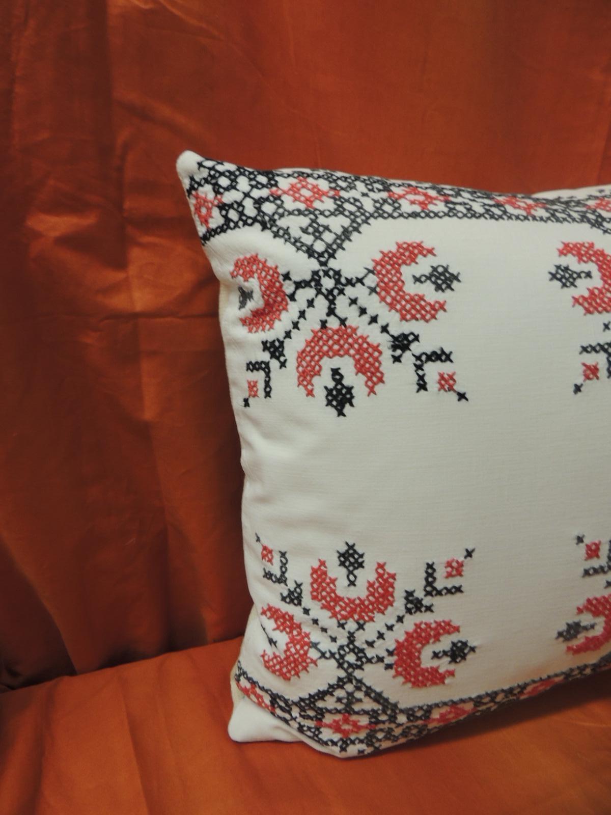 Vintage cross-stitch red, black and white German embroidery decorative pillow.
The textile panel in the front has a red and black embroidery onto a white cotton field. 
The antique embroidery in the front of the accent pillow depicts a bouquet of
