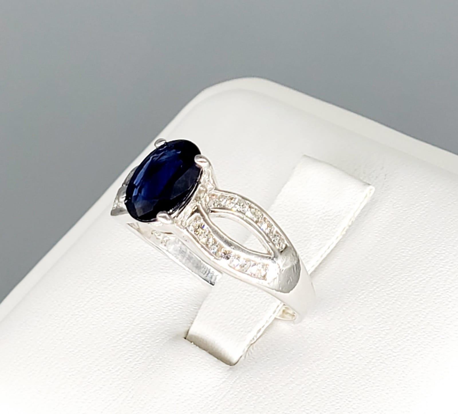 Vintage 2 Carats Blue Sapphire & Diamonds Bow Design Engagement Ring. The ring is a beautiful piece sparkling from every angle a true master piece. Featuring a center blue sapphire weighting approx 1.50 carat and is surrounded by 0.50 carats white